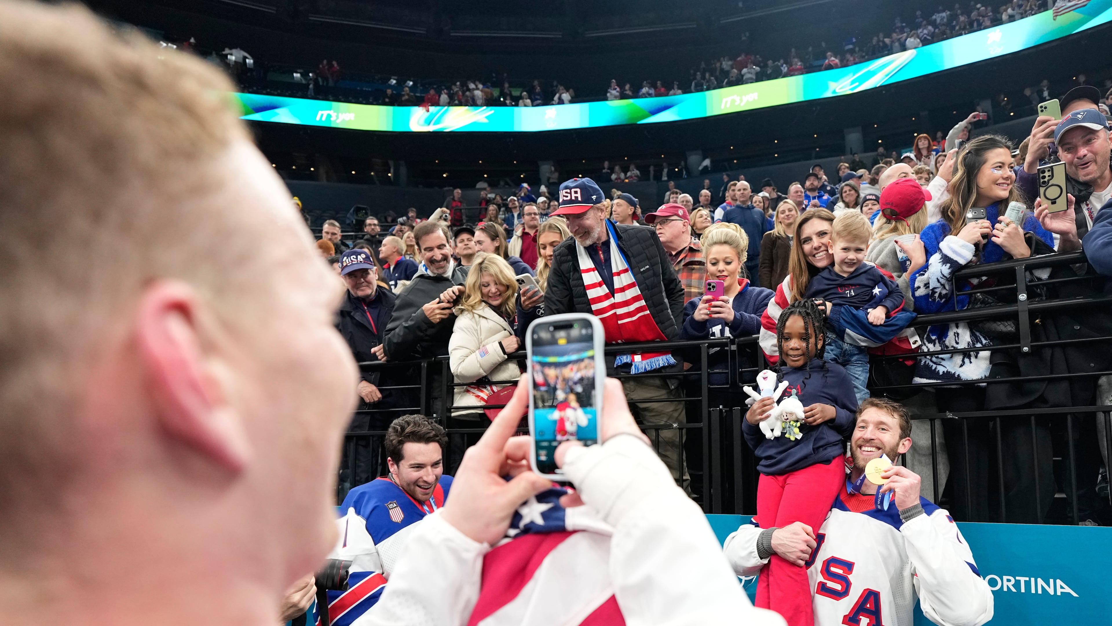 FILE - United States' Jaccob Slavin (74) poses with his gold medal after the men's ice hockey gold medal game between Canada and the United States at the 2026 Winter Olympics, in Milan, Italy, Feb. 22, 2026. (AP Photo/Hassan Ammar, File)