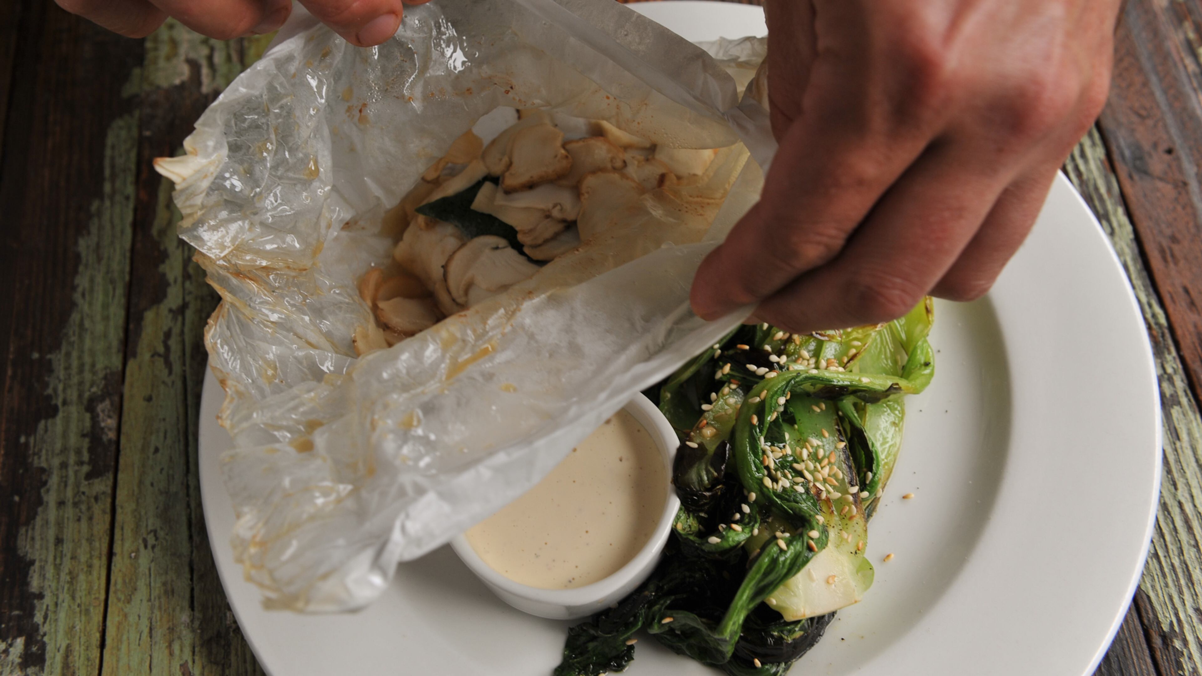 Hog snapper baked in parchment with matsutake mushrooms, bok choi and "umami" mayo at Cakes & Ale. (Beckysteinphotography.com)