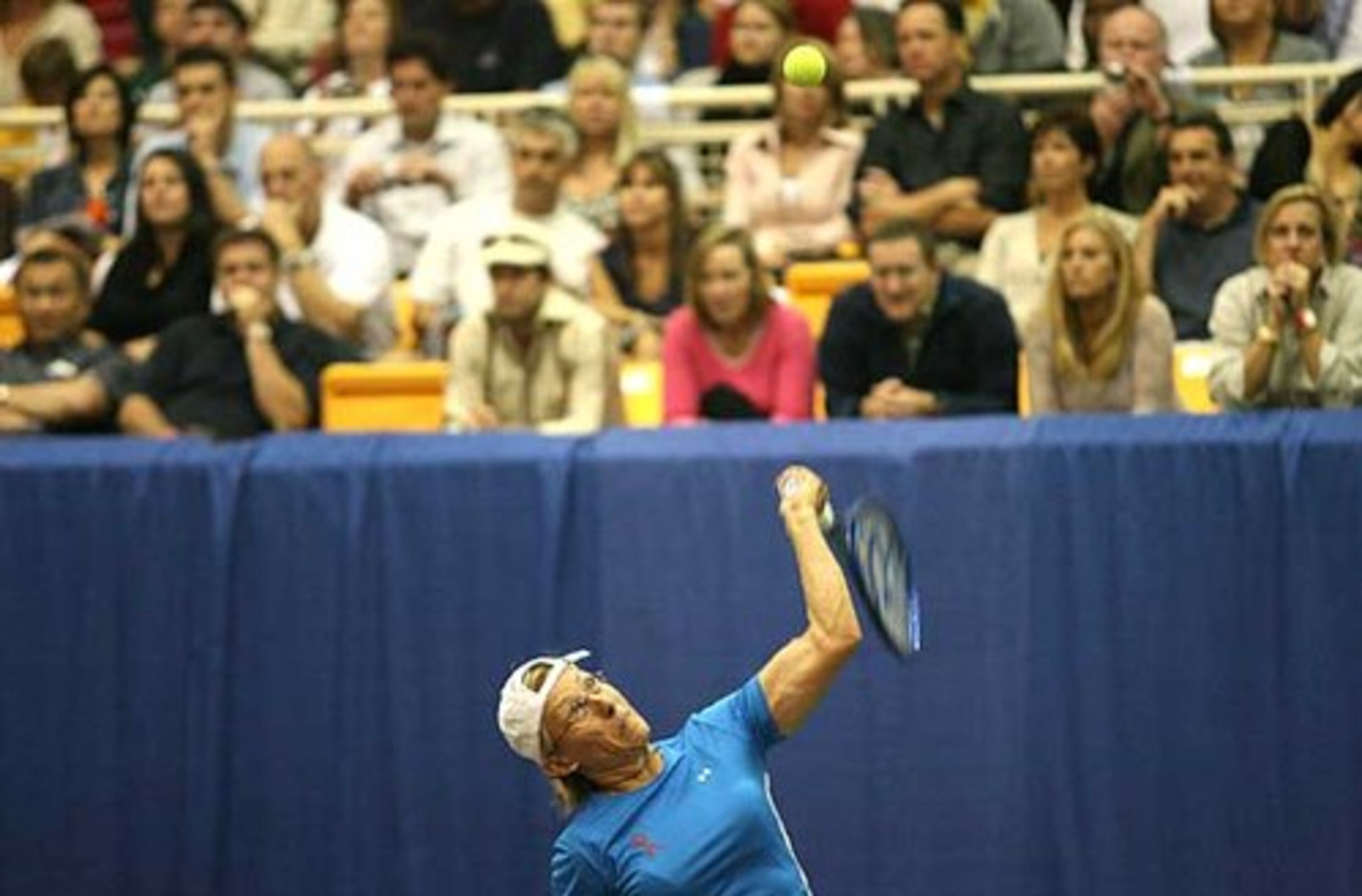 Martina Navratilova hits a serve during the Advanta WTT Smash Hits tennis event in an exhibition match against Melanie Oudin of Marietta, the top ranked American junior player and No. 2 in the world.