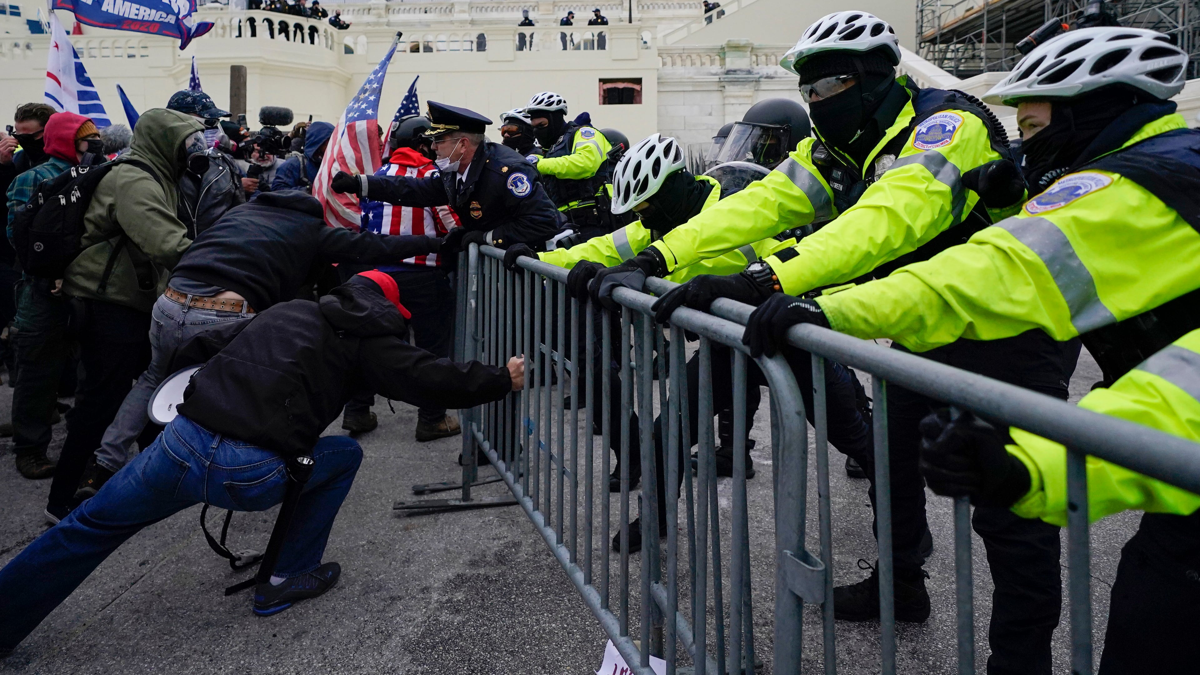 FILE - Metropolitan Police Department officers try to hold back rioters on the West Front at the U.S. Capitol on Jan. 6, 2021, in Washington. (AP Photo/Julio Cortez, File)