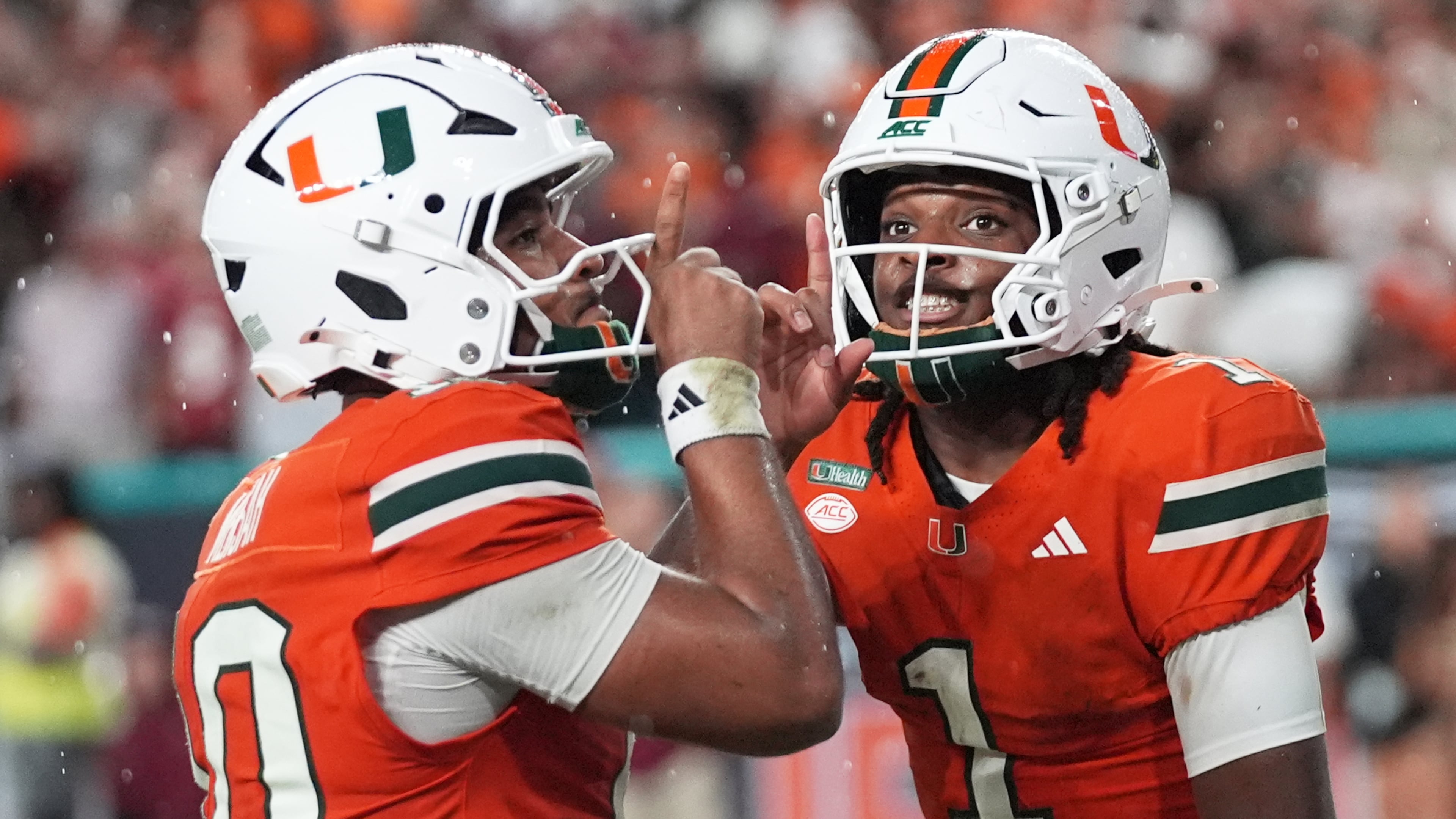 Miami wide receiver Malachi Toney (1) celebrates with quarterback Darian Mensah after scoring a touchdown during the first half of an NCAA college football game against Florida State, Saturday, Oct. 17, 2026, in Miami Gardens, Fla. (AP Photo/Lynne Sladky)