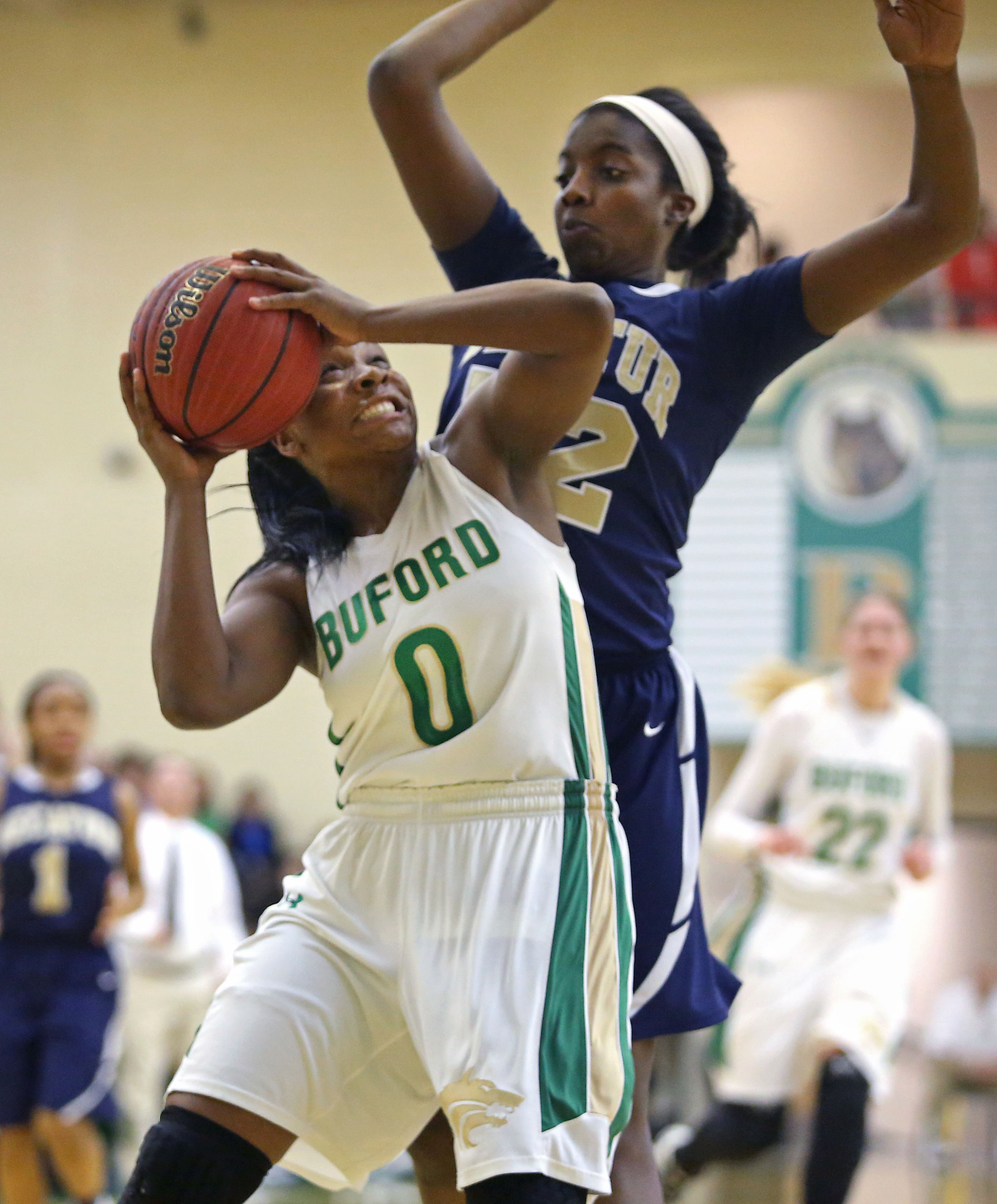 Buford's Camille Anderson (0) goes up strong as she is fouled by Decatur's Kristin Munson in their game Monday night in Buford. Anderson scored 16 points to lead Buford. JASON GETZ / SPECIAL