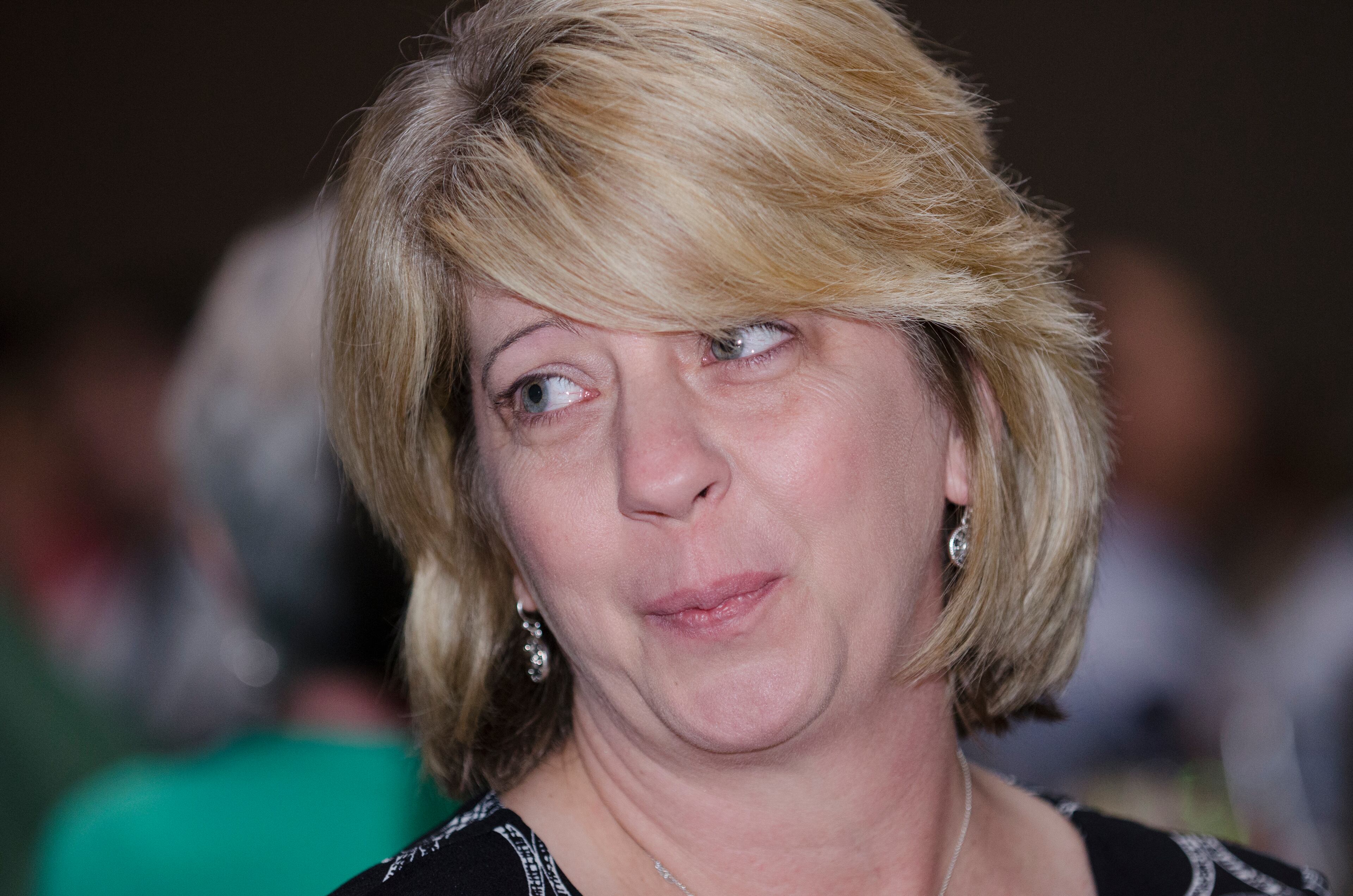 Saralyn Lee winner of Celebrating Nurses AJC Jobs Nursing Excellence Awards watches her video documentary the awards luncheon Tuesday, May 6, 2014 at the Cobb Galleria. (Photo by Barry Williams/Special)
