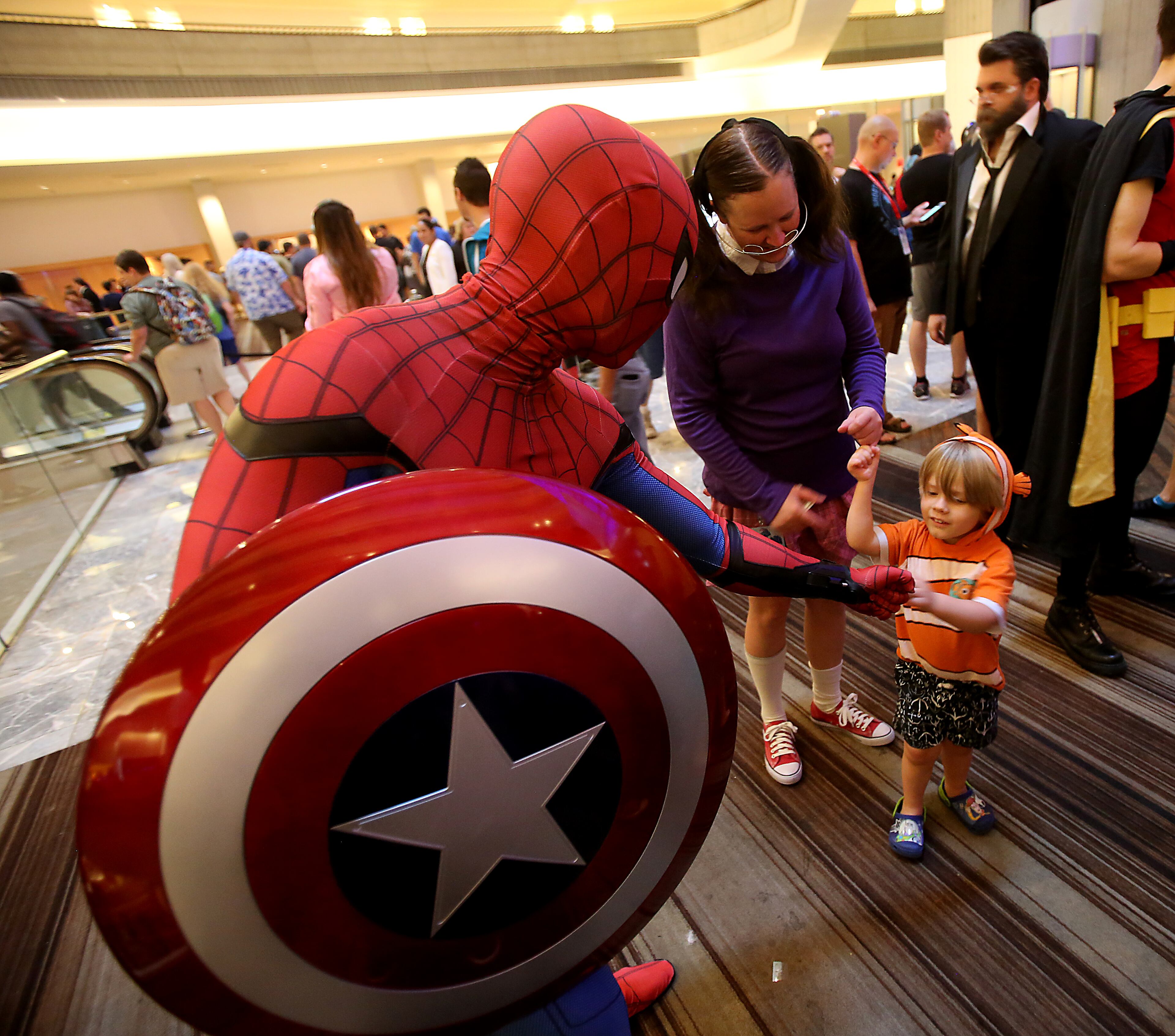 September 1, 2017 Atlanta - Jimmy Nguyen, 27 of Atlanta, greets a small Dragon Con 2017 attendee, who admired his Spider-Man outfit. Nguyen was extra excited about being able to see Marvel comic master Stan Lee in a panel Friday afternoon. Dragon Con 2017 is in full fledge in its 31st year. With over 80,000 people expected to fill the streets of downtown Atlanta, the three-day event has always brought the best out of attendees and their costume-making abilities. RYON HORNE/RHORNE@AJC.COM