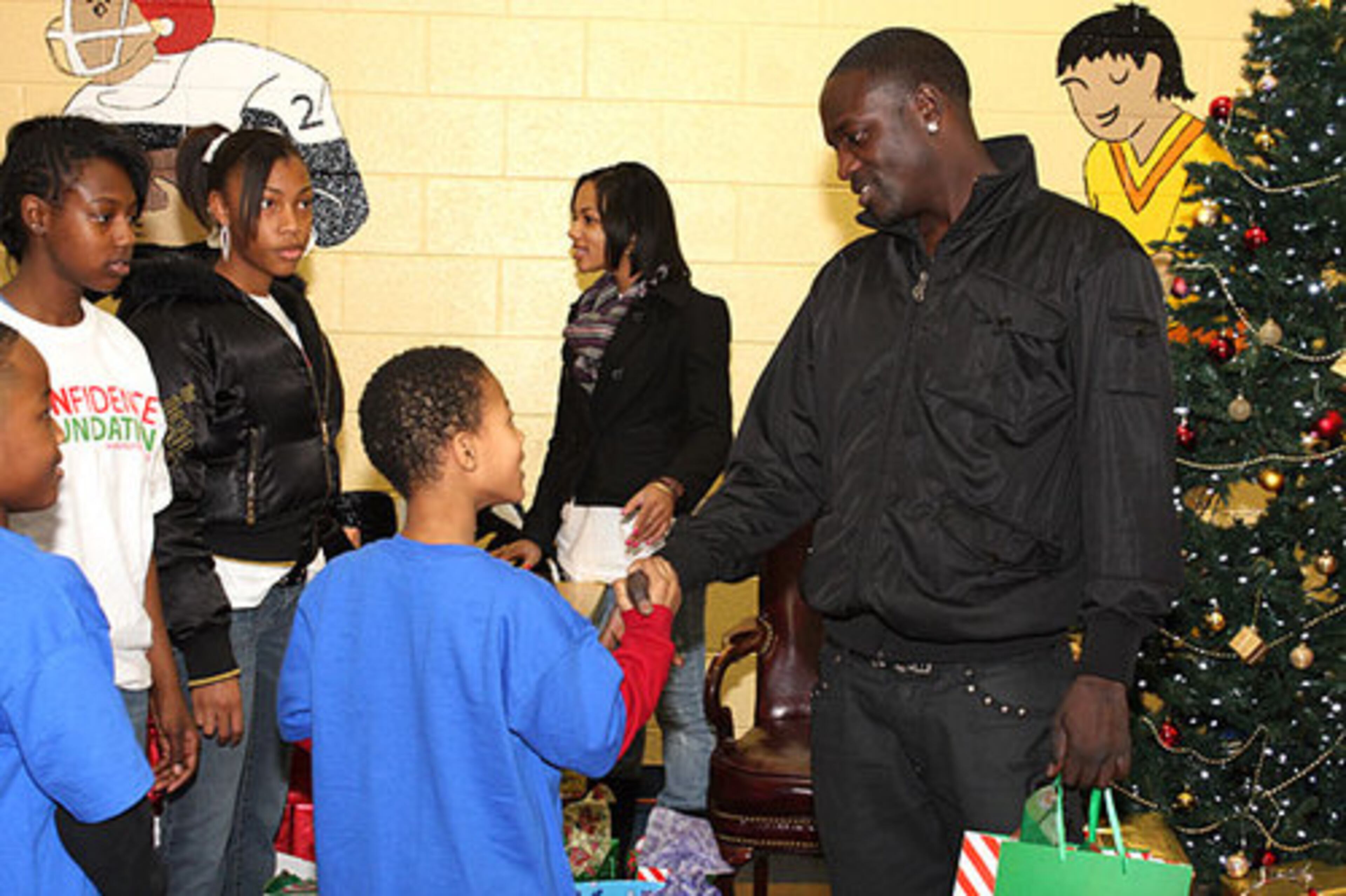 This young man was among those getting a firm handshake along with a present from Akon.