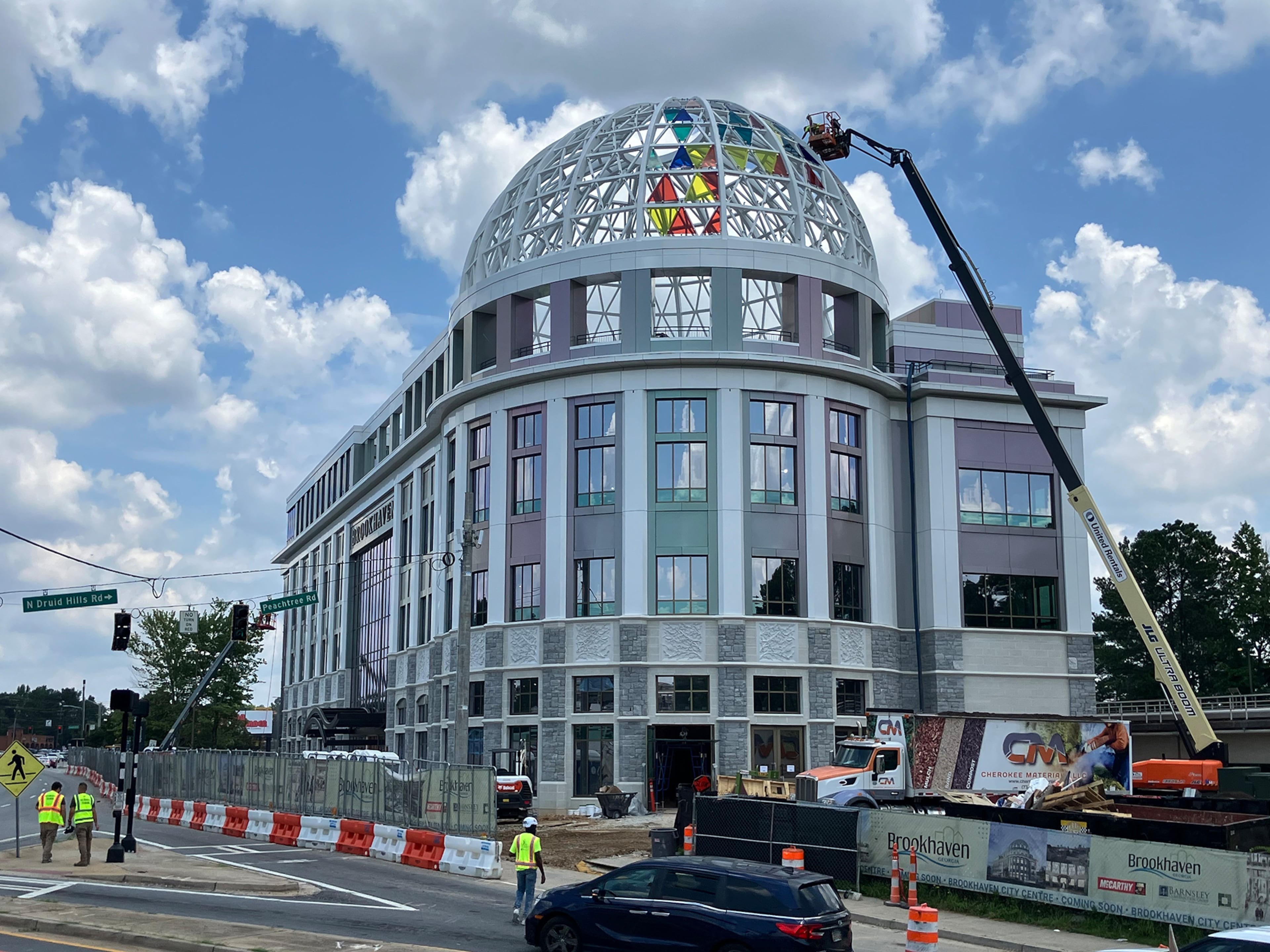 Brookhaven city officials have various theories for why the colors of the glass panes on the City Centre dome were much brighter than expected, including manufacturer error and different lighting when the samples were viewed. (Reed Williams/AJC)