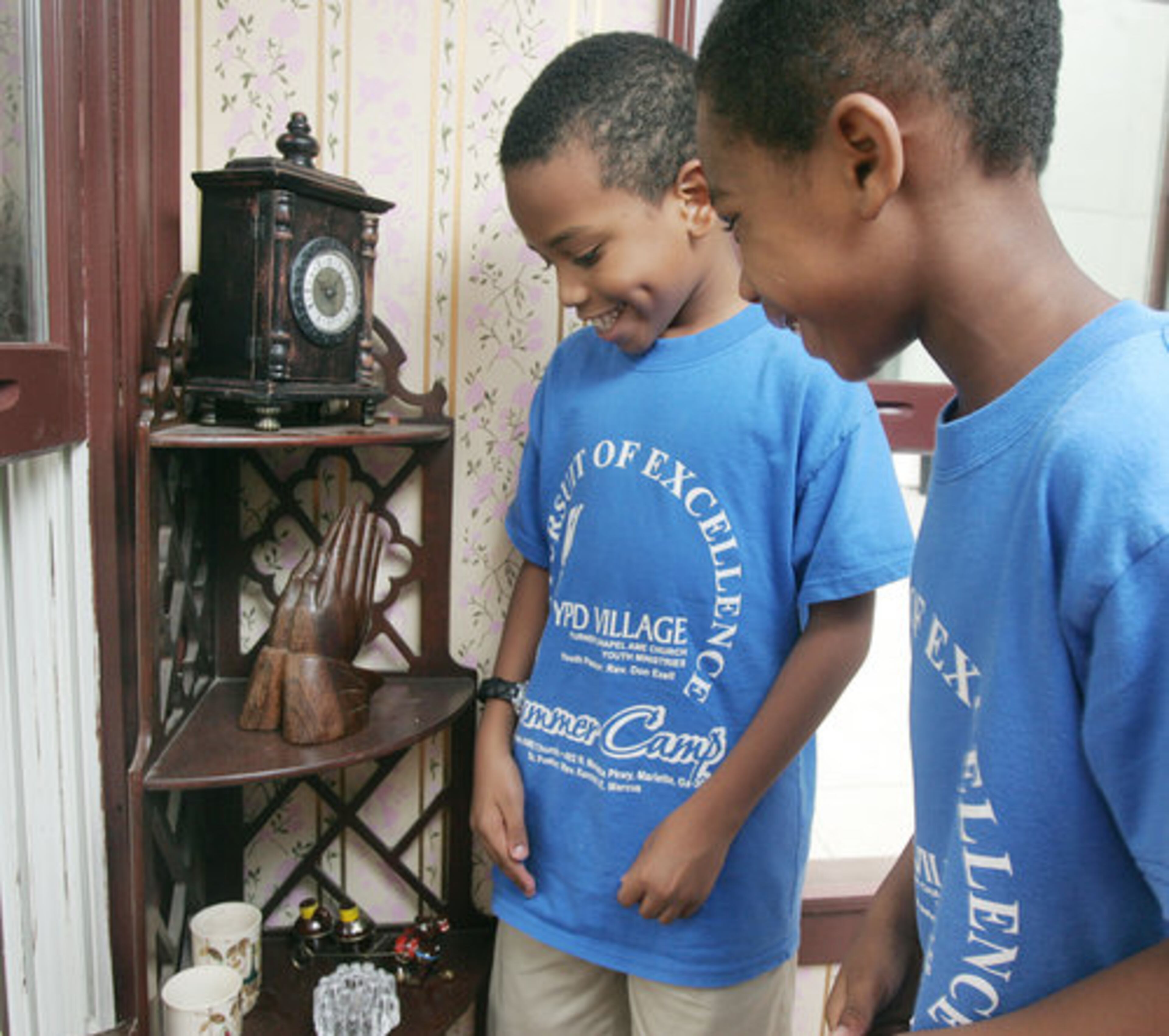 Tyler Burston (left) and Jonathan Hicks, both 8, inspect some knickknacks in the King home. They were among the first to tour the replica house.