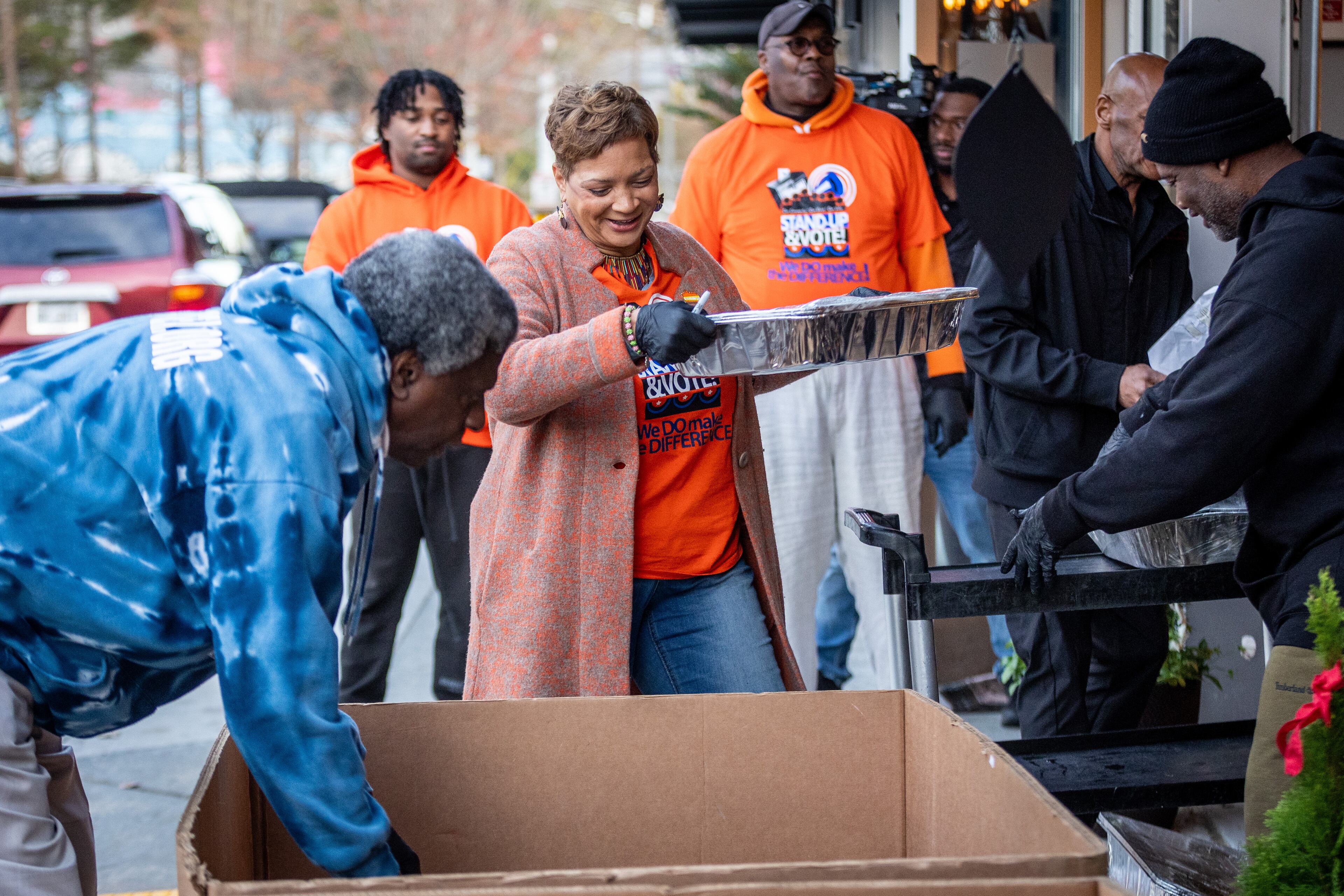 Beborah Scoot (Center) loads trays of food into boxes that will be loaded onto a truck and delivered to people around Atlanta on Thursday, November 23, 2023. (Steve Schaefer/steve.schaefer@ajc.com)
