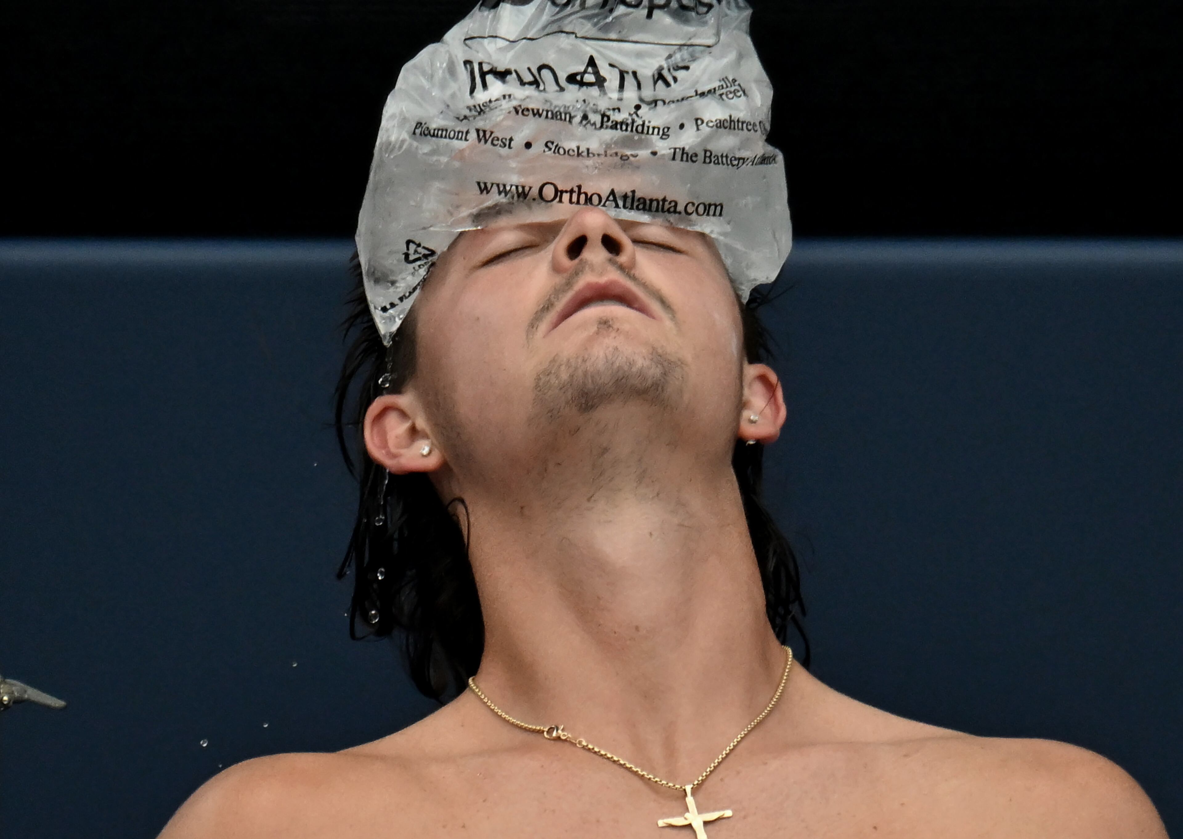 J.J. Wolf cools off with a bag of ice as he plays Taylor Fritz during a semifinal match at the 2023 Atlanta Tennis Open at Atlantic Station, Saturday, July 29, 2023, in Atlanta. (Hyosub Shin / Hyosub.Shin@ajc.com)
