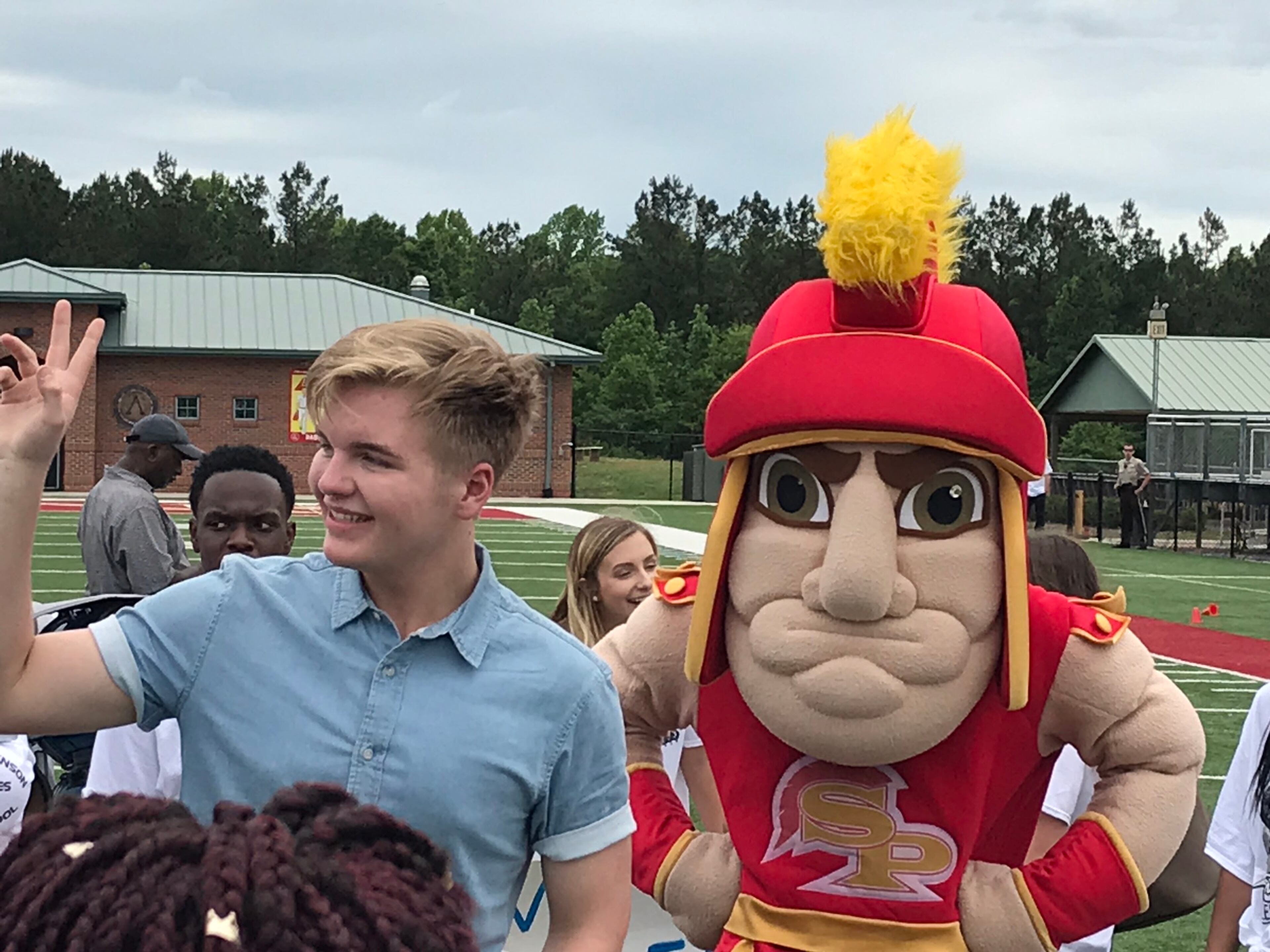 Caleb Lee Hutchinson with the Spartan mascot for his alma mater. CREDIT: Rodney Ho/rho@ajc.com