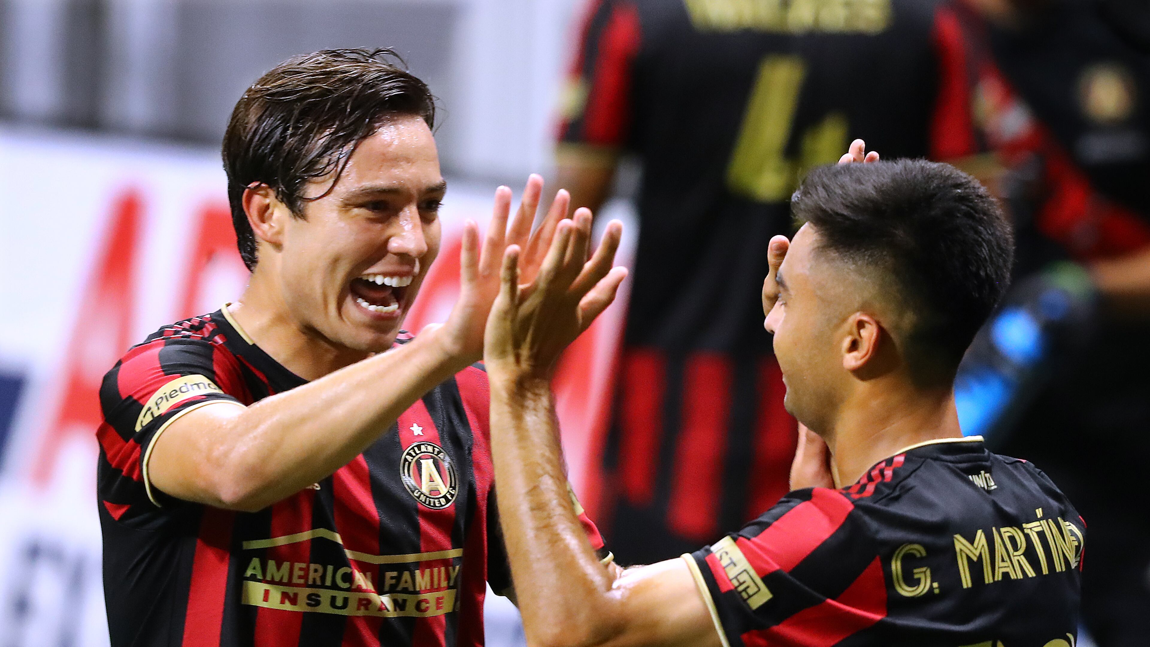 082220 Atlanta: Atlanta United forward Erick Torres (left) gives midfielder Pity Martinez a double high five after Martinez scored his second goal of the night against Nashville SC during the second half for the 2-0 victory in a MLS soccer match on Saturday, August 22, 2020 in Atlanta. Curtis Compton ccompton@ajc.com