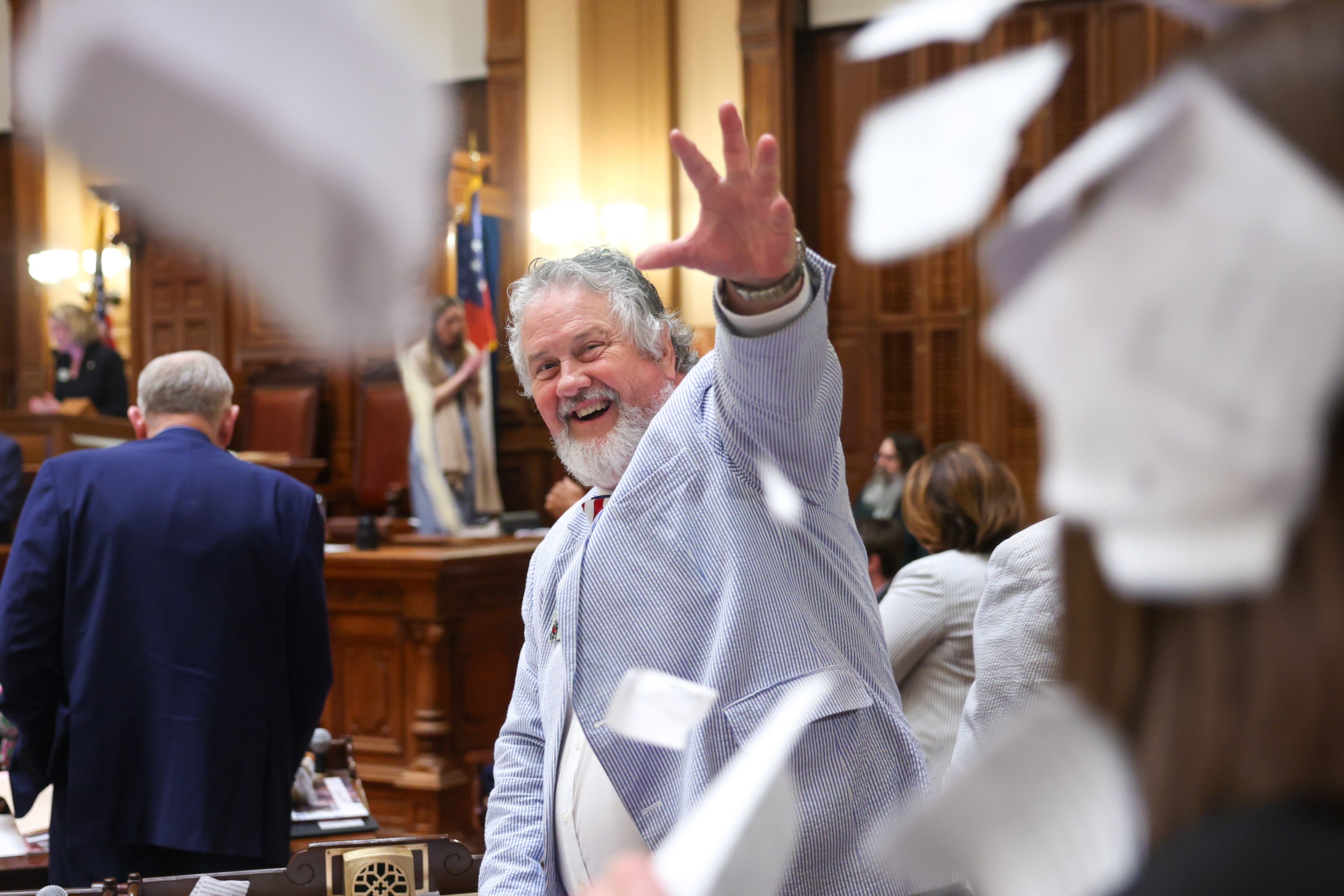 State Rep. Emory Dunahoo, R-Gillsville, tosses papers in the House of Representatives on the final day of the legislative session in April. (Arvin Temkar/AJC)