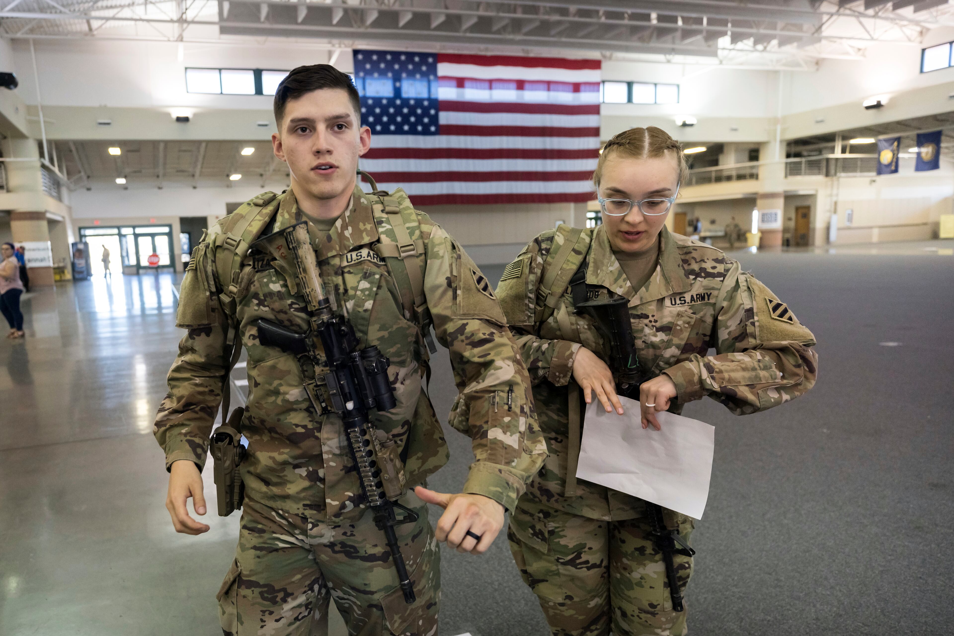SAVANNAH, GA - MARCH 2, 2022: Marissa Elizardo, right, and her husband Michael Elizardo, left, prepare to deploy to Germany with the U.S. Army 3rd Infantry Division, 1st Armored Brigade Combat Team, Wednesday Mar. 2, 2022 in Savannah, Ga. The 180 troops on the flight are being sent as reinforcements for various NATO allies in Eastern Europe. (AJC Photo/Stephen B. Morton)