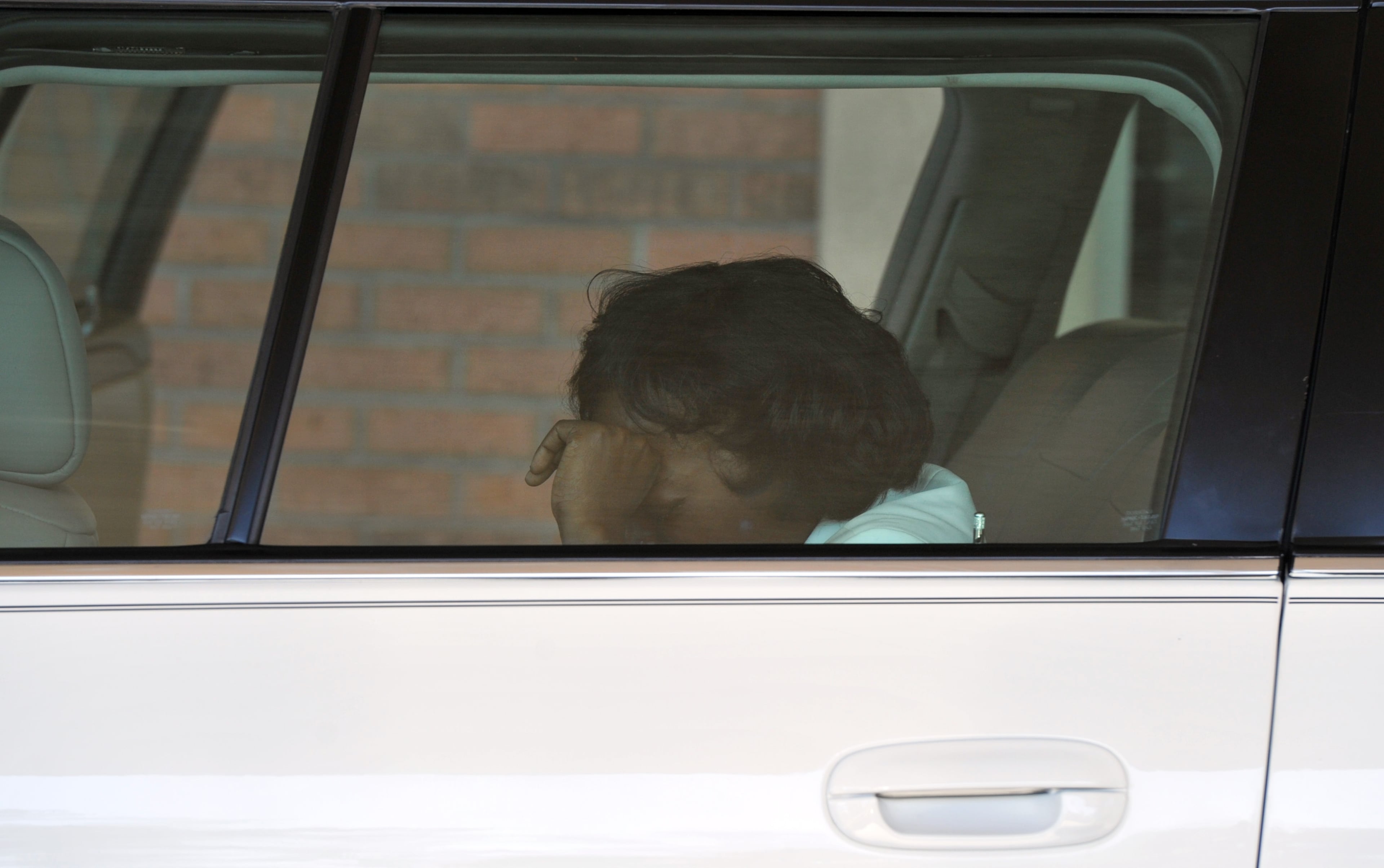 Emani Moss' grandmother Robin Moss cries inside the funeral car after the funeral service for Emani Moss, who was found dead, her body burned, in a trash can, at Gregory B. Levett & Sons Funeral Home in Lawrenceville on Wednesday, November 13, 2013. Emani Moss will be laid to rest Wednesday in Gwinnett after the grandmother won court approval to bury the child. Emani's grandmother had to get a court order to keep the birth mother, who surrendered custody, from claiming the body. HYOSUB SHIN / HSHIN@AJC.COM
