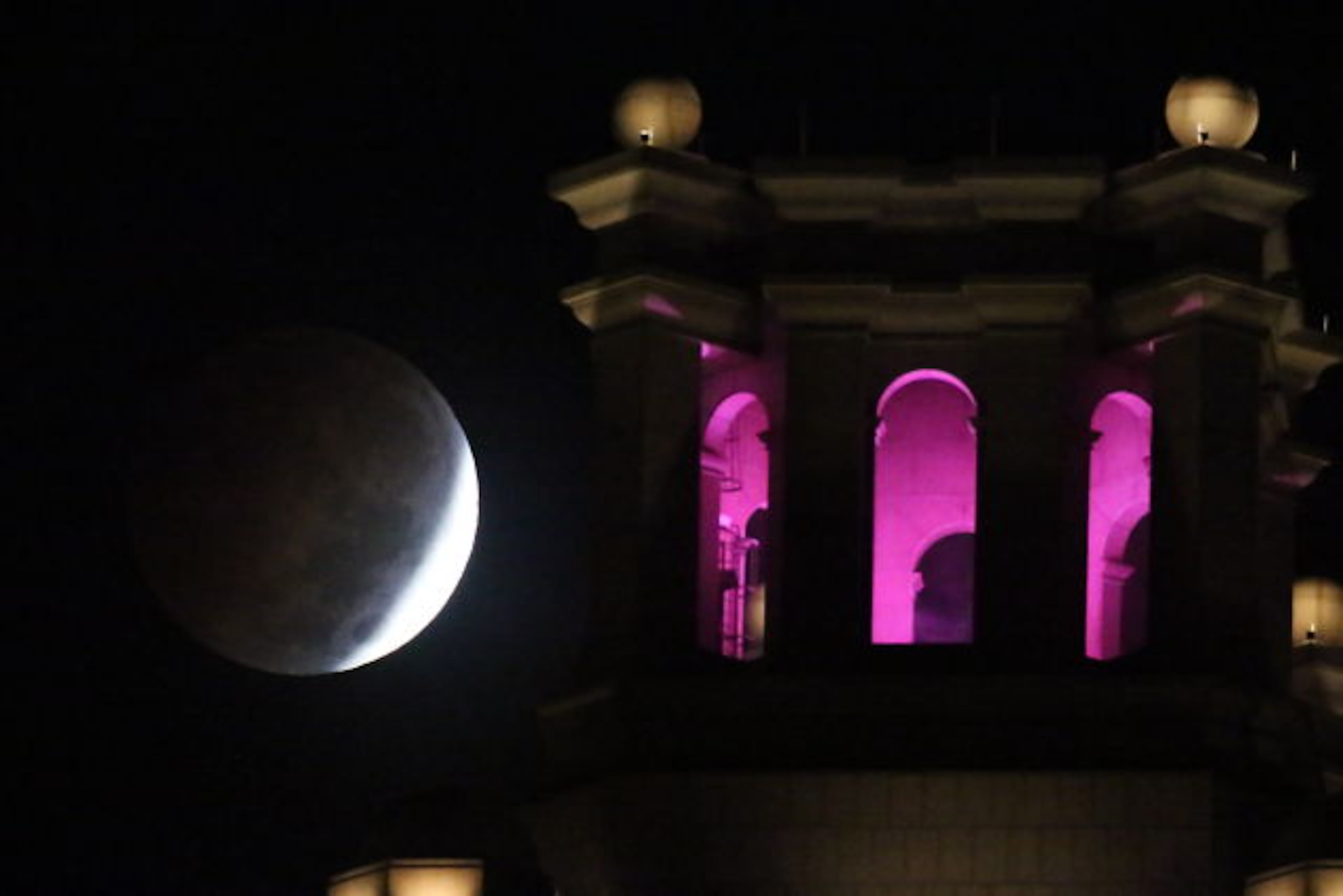 Spink spent about a half hour running up and down the embankment where he'd parked taking different frames of the scene, moving around and trying to line up the moon just right. "I was using a monopod just for mobility and to be quick. I liked this photo because the pink and the columns made it look cool."