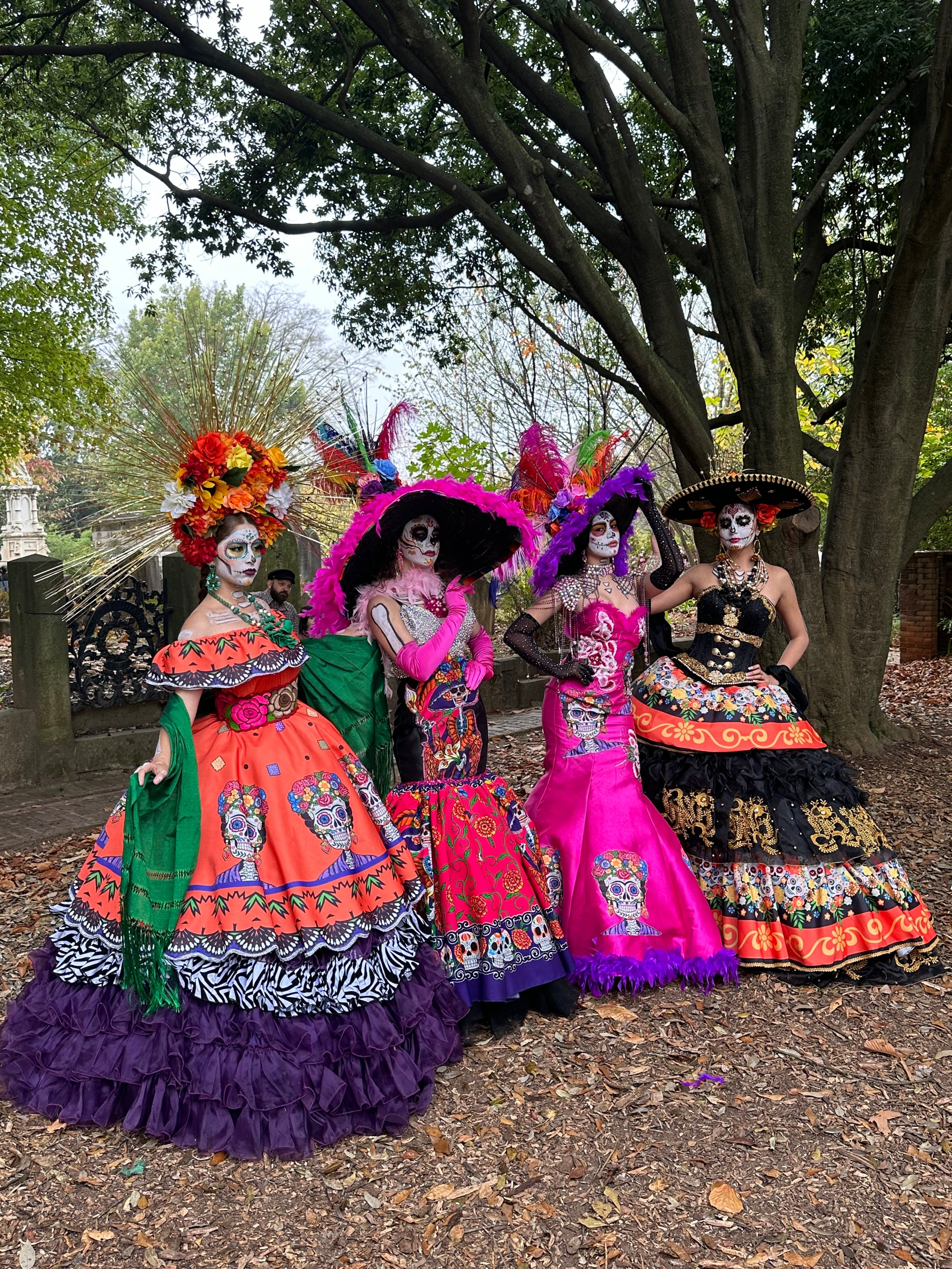 Four women dressed in elaborate la Catrina dresses celebrate Dia de los Muertos in Oakland Cemetery in 2024. (Courtesy of Kristy A. Gomez)