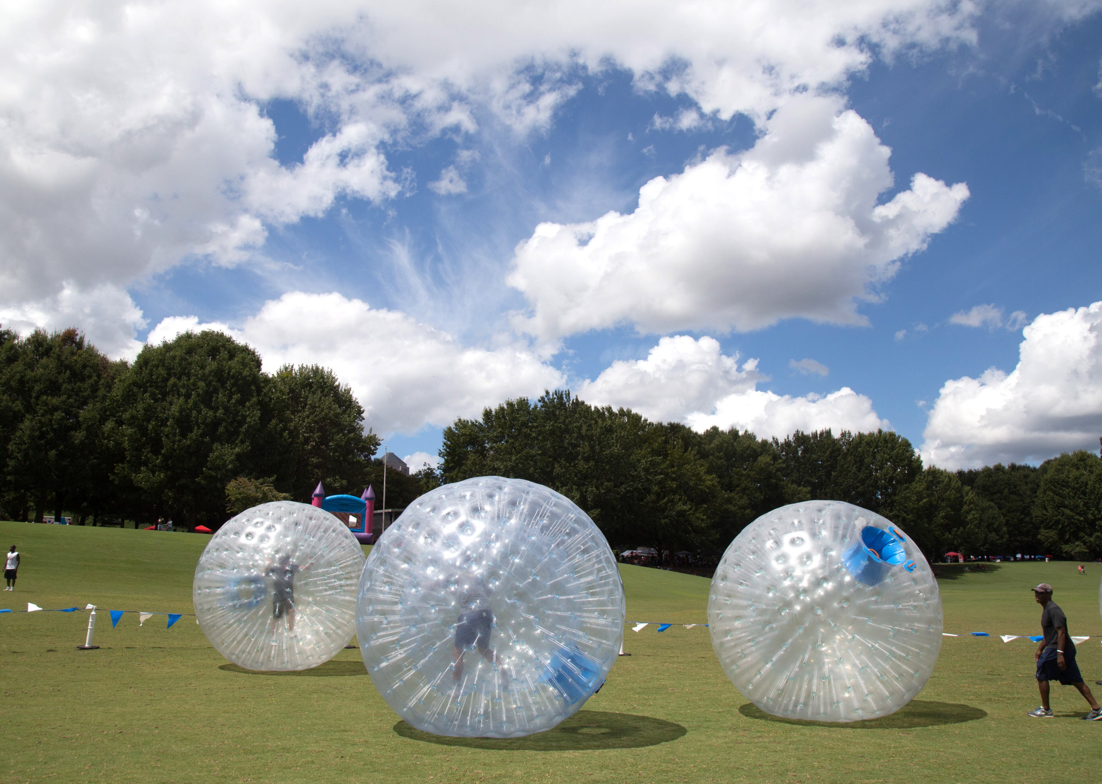 People ride inside Zorb balls during the Pure Heat Community Festival celebrating Black Gay Pride Weekend in Piedmont Park Sunday, September 2, 2018.
(Photo: STEVE SCHAEFER / SPECIAL TO THE AJC)