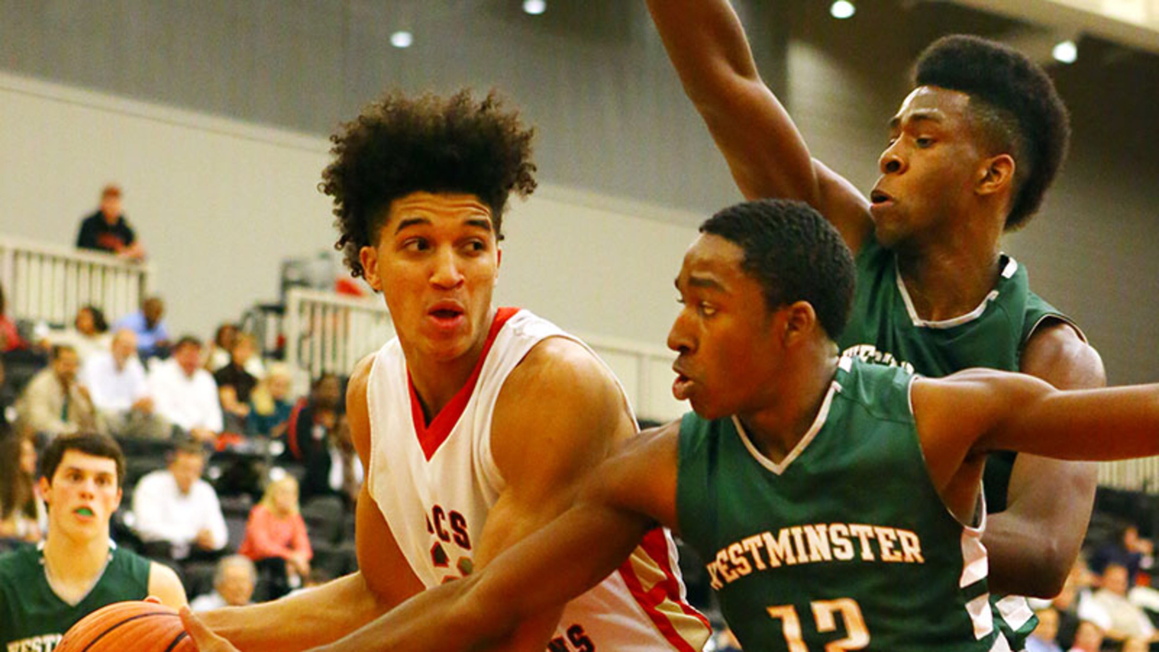 011414 NORCROSS: GAC Spartans Isaiah Wilkins looks to pass around Westminster Wildcats defender Marquavious Strozier during the first half of their high school basketball game at Greater Atlanta Christian High School on Tuesday, Jan. 14, 2014, Norcross . CURTIS COMPTON / CCOMPTON@AJC.COM Greater Atlanta's Isaiah Wilkins scored 17 points and four blocked shots Tuesday and helped the Class AA No. 1-ranked Spartans to a 71-18 win over Westminster. (Curtis Compton / AJC)