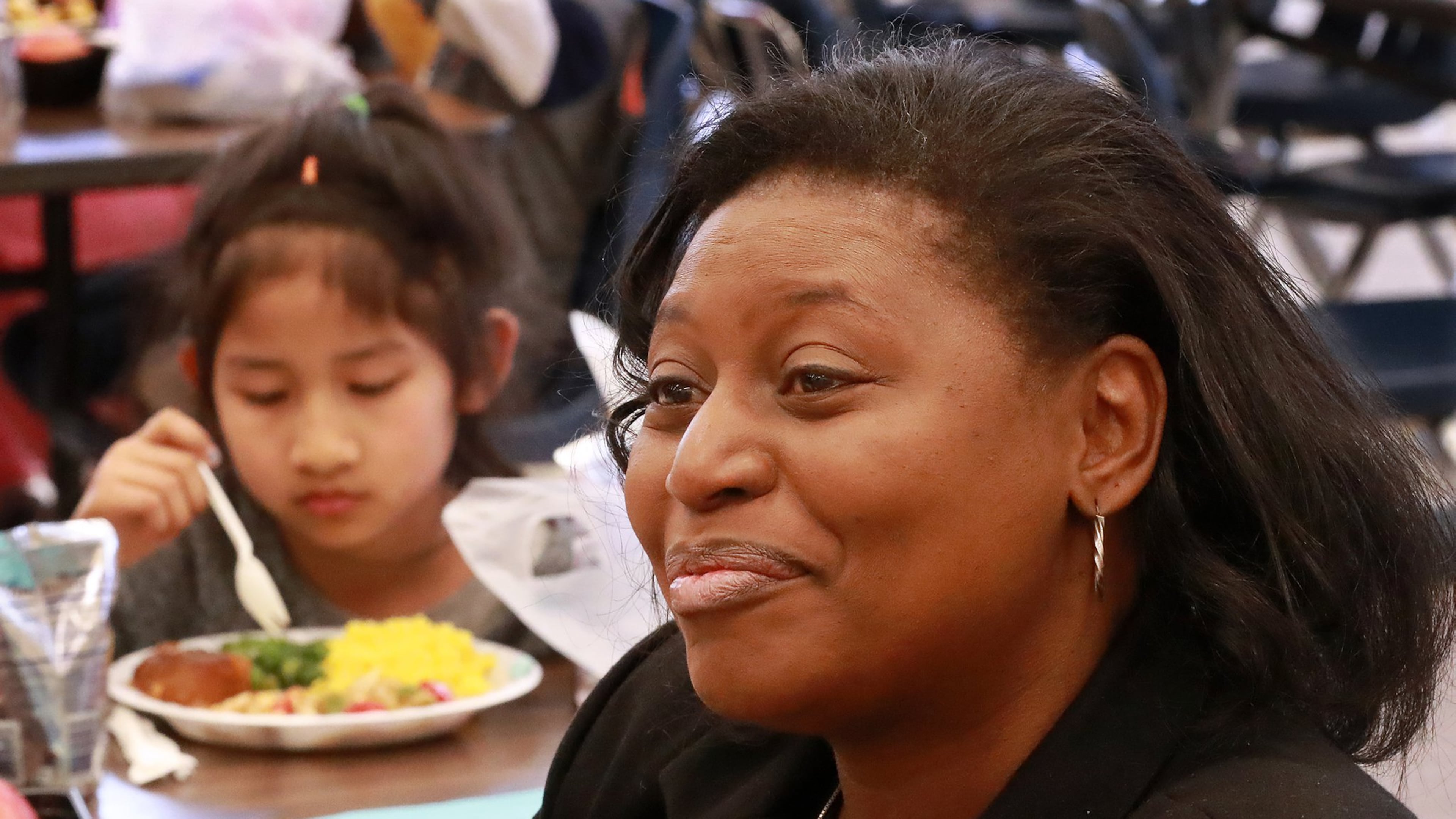 Principal Stephanie Brown-Bryant discusses the benefit of students having lunch served during spring break. Beauty Lay, 7, is one of hundreds enjoying their meal at Indian Creek Elementary School on Tuesday, April 2, 2019, in Clarkston. CURTIS COMPTON/CCOMPTON@AJC.COM