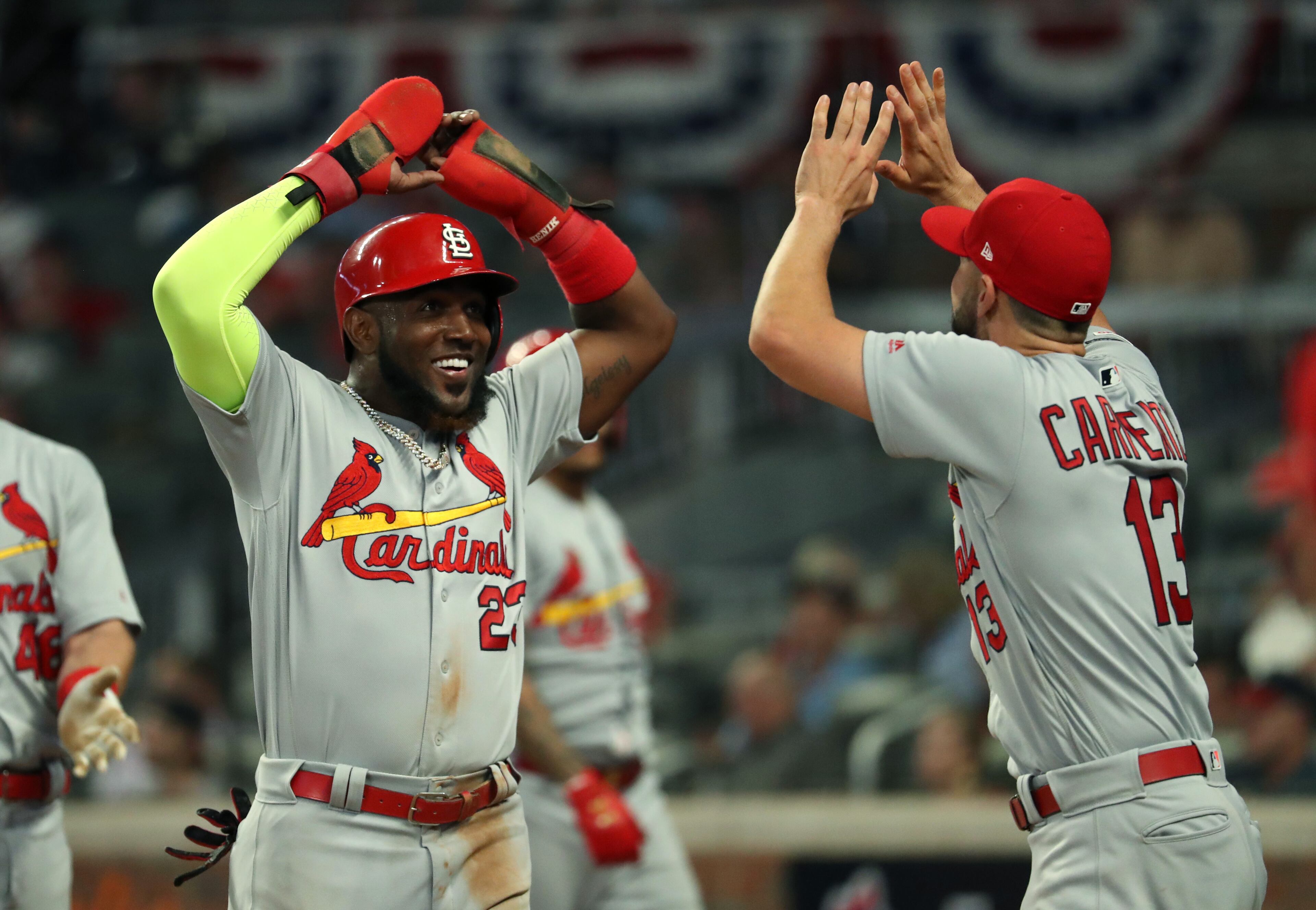 St. Louis Cardinals left fielder Marcell Ozuna (23) celebrates a run with third baseman Matt Carpenter (13) in the ninth inning. (JASON GETZ/SPECIAL TO THE AJC)