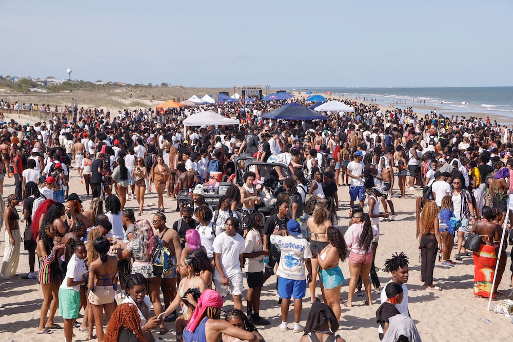 A crowd of partiers gather on the beach for Orange Crush in Tybee Island in April 2025. (Natrice Miller/AJC)