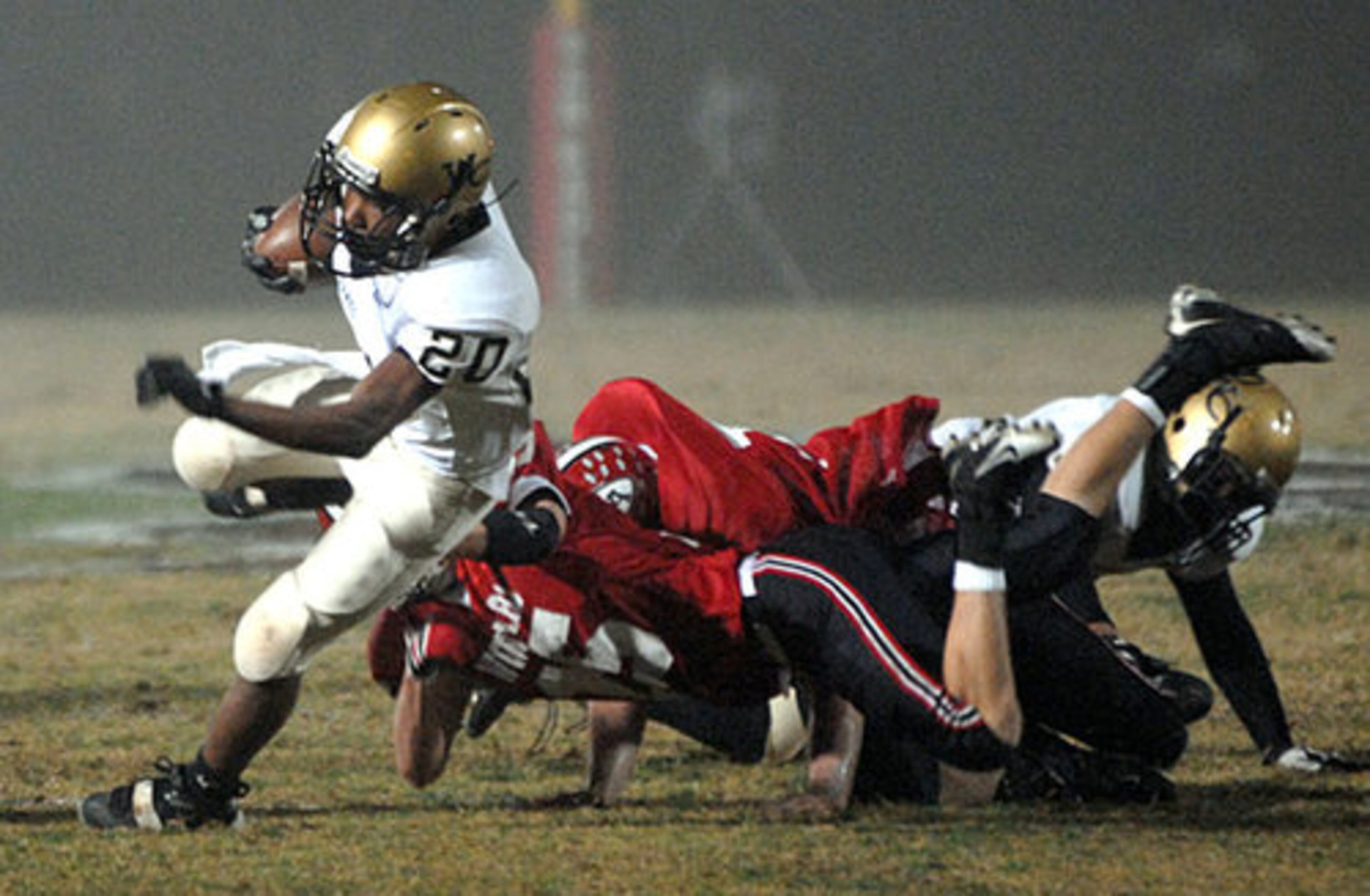 Golden Hawk Montravoius Gladden (No. 20) breaks tackles.