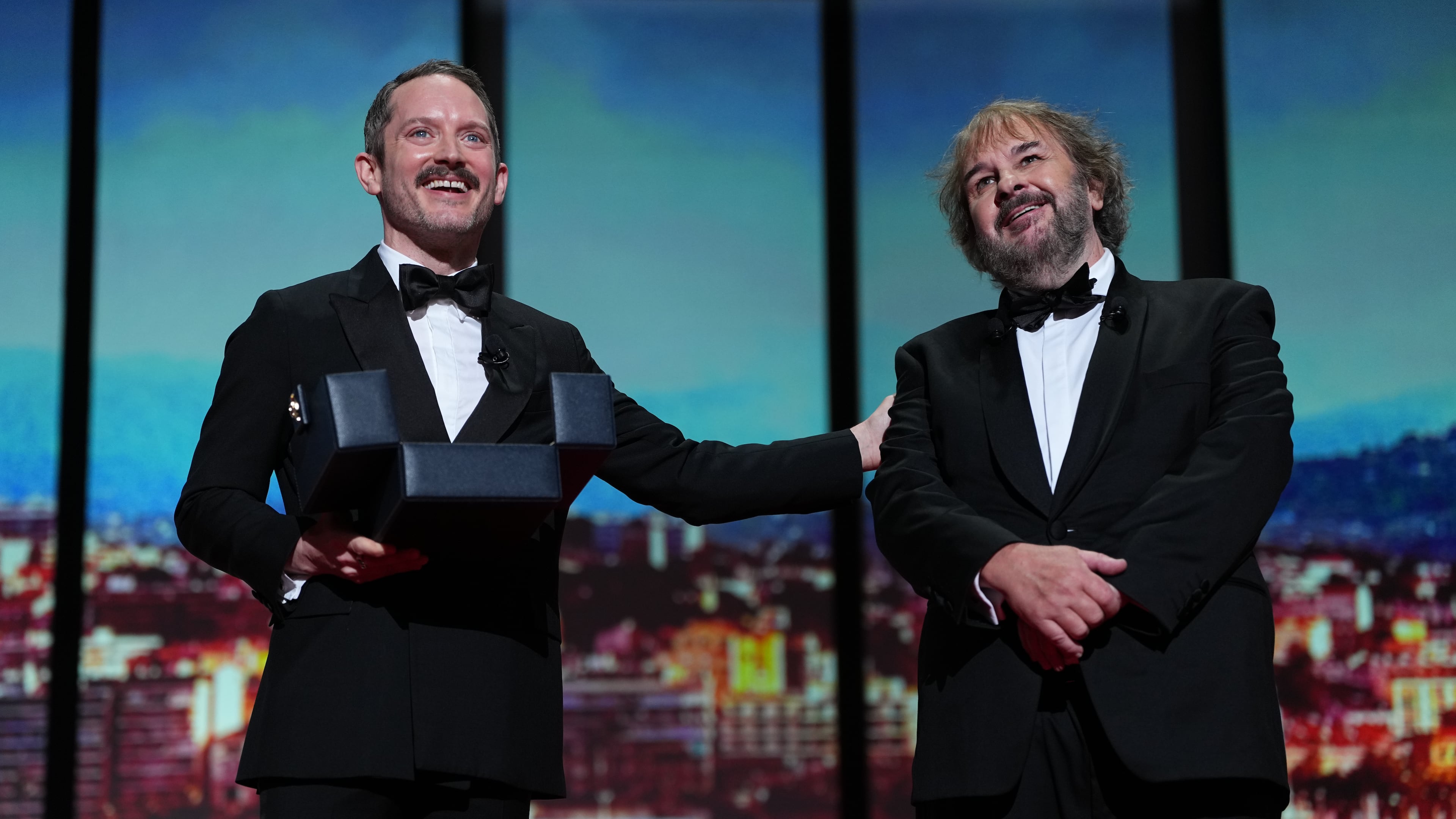 Elijah Wood, left, and director Peter Jackson, recipient of the honorary Palme d'Or, pose for photographers during the opening ceremony of the 79th international film festival, Cannes, southern France, Tuesday, May 12, 2026. (Photo by Scott A Garfitt/Invision/AP)