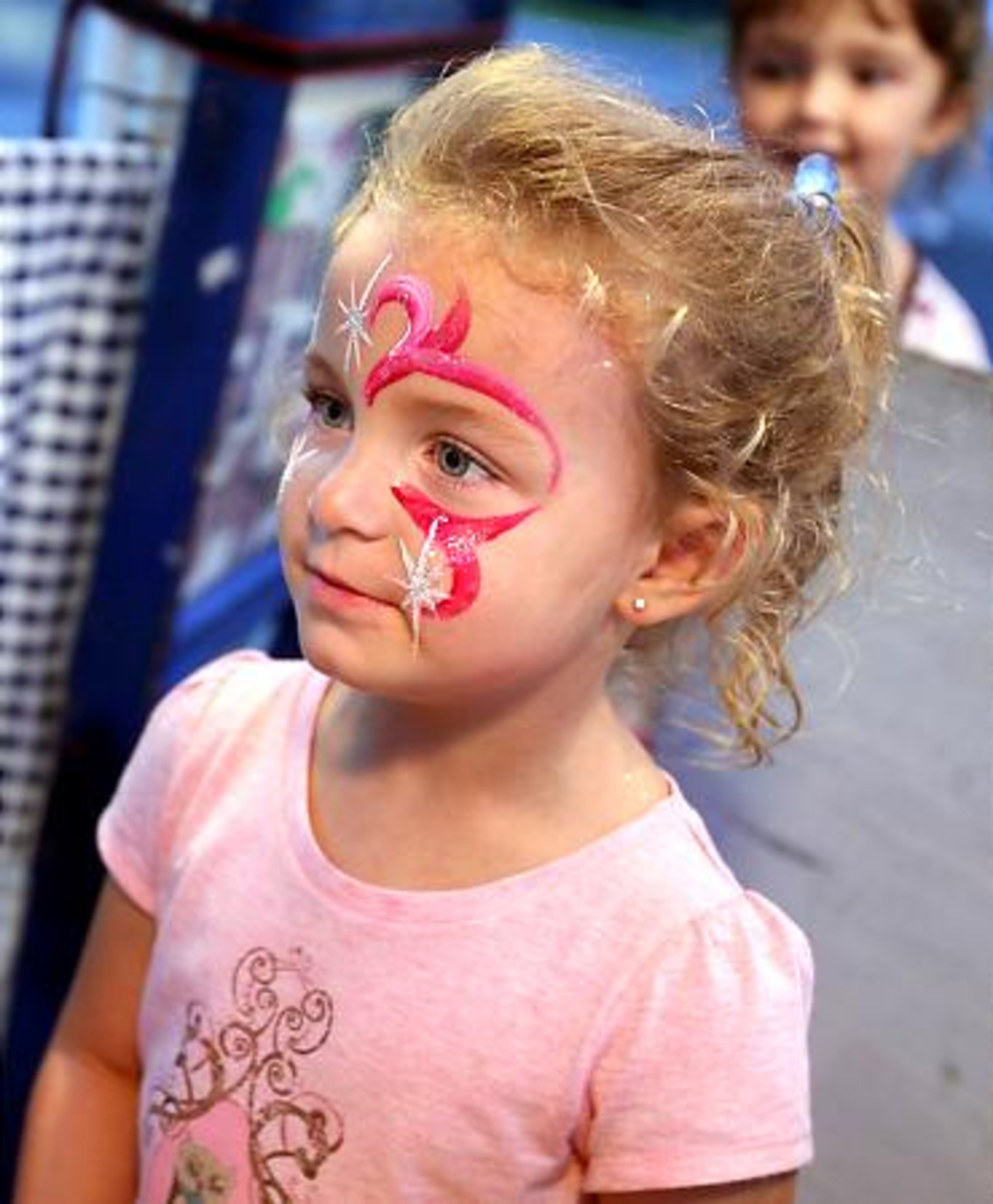 Autumn Atcheson, 4, of Grayson, admires her face paint, recently applied by Jones.