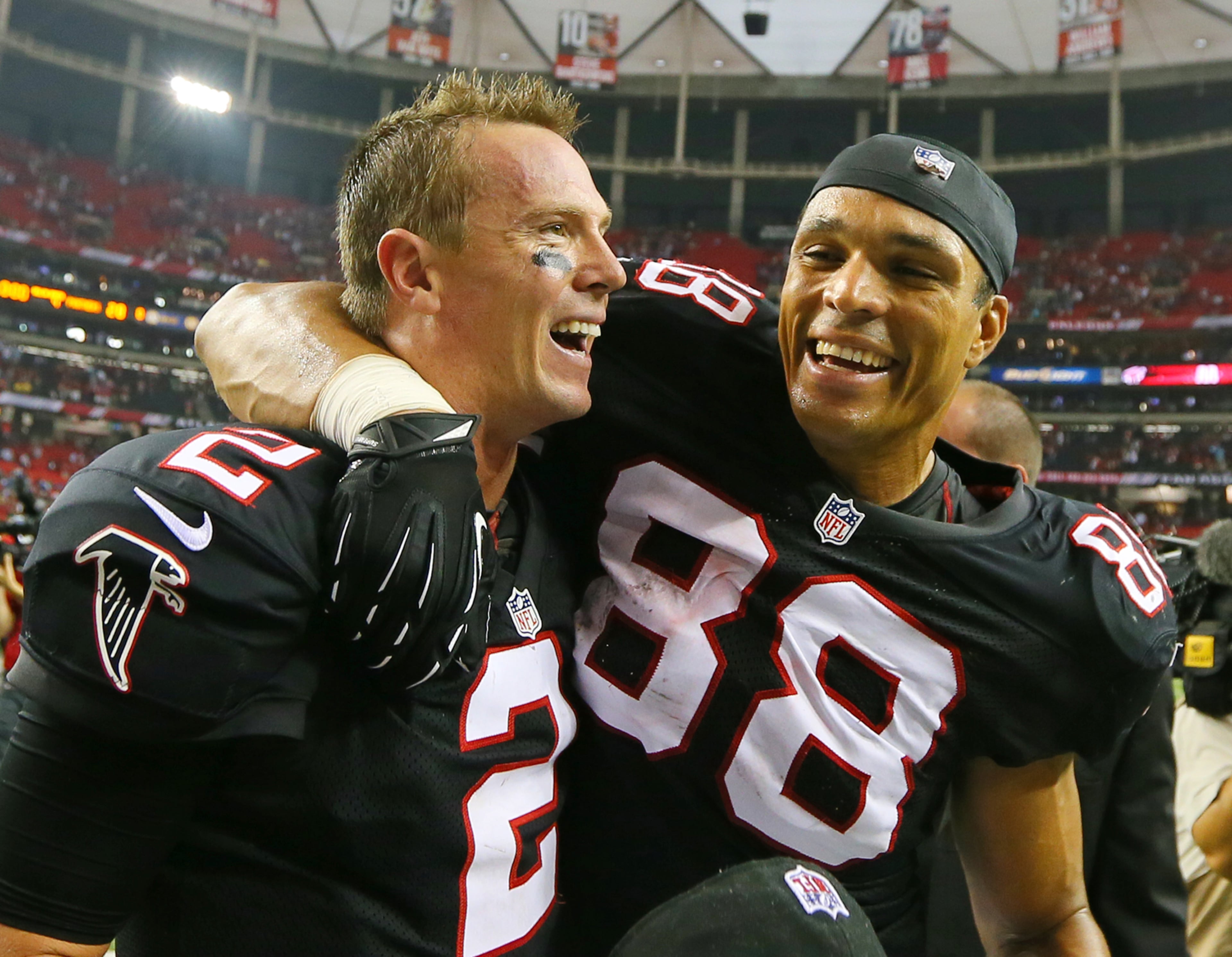 093012 ATLANTA: Falcons quarterback Matt Ryan and tight end Tony Gonzalez celebrate a 30-28 victory over the Carolina Panthers to remain undefeated at the Georgia Dome in Atlanta on Sunday , Sept. 30, 2012. CURTIS COMPTON / CCOMPTON@AJC.COM