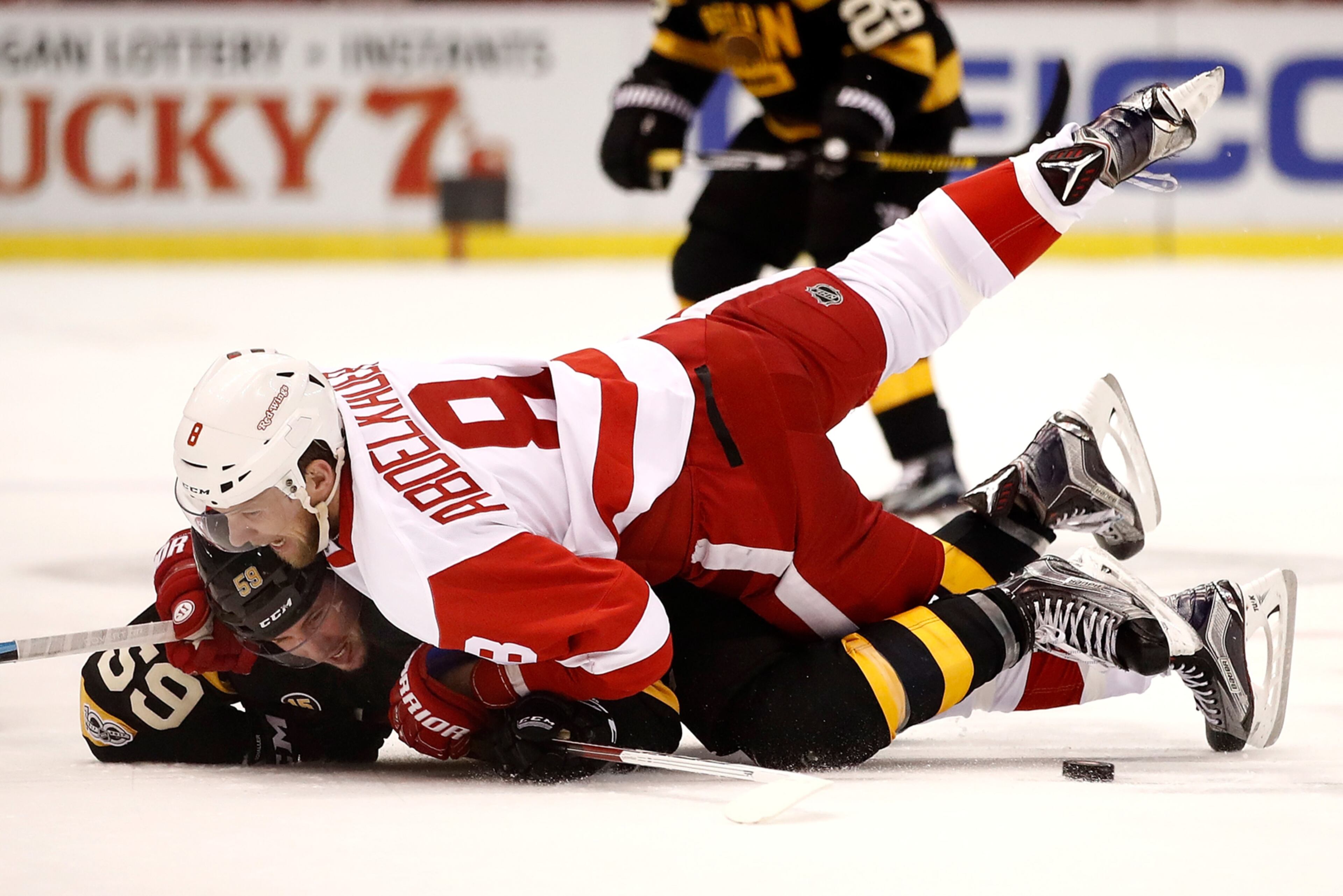 DETROIT, MI - JANUARY 18: Justin Abdelkader #8 of the Detroit Red Wings takes down Tim Schaller #59 of the Boston Bruins during the first period at Joe Louis Arena on January 18, 2017 in Detroit, Michigan. (Photo by Gregory Shamus/Getty Images) *** BESTPIX ***