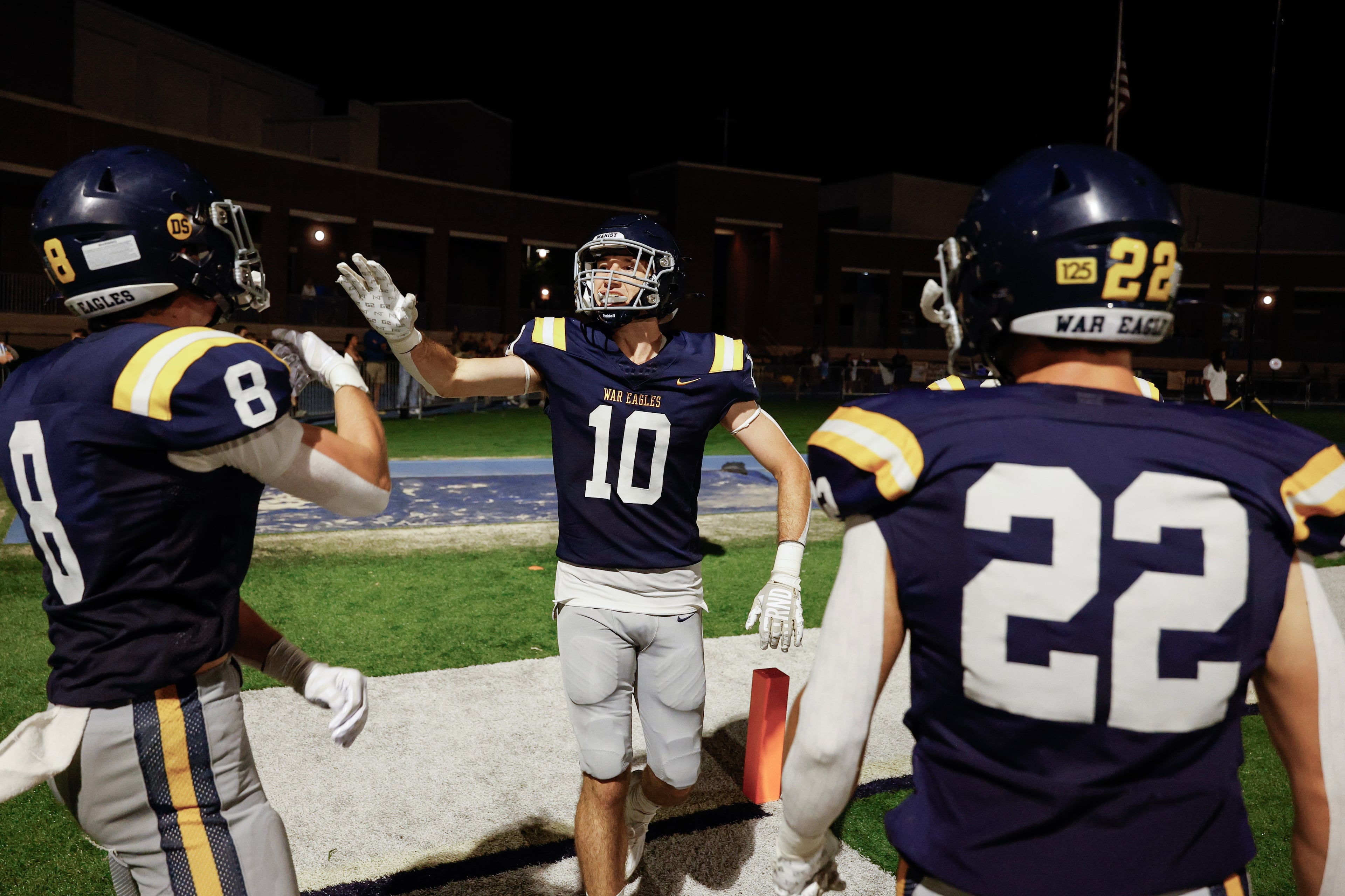 Marist's Engin McCarthy (center) celebrates his pick-six interception against Blessed Trinity with Jake McLaren (left) during the second half of a high school football game between Blessed Trinity and Marist, Friday, Sept. 25, 2026, in Atlanta. (Erik S. Lesser for the AJC)