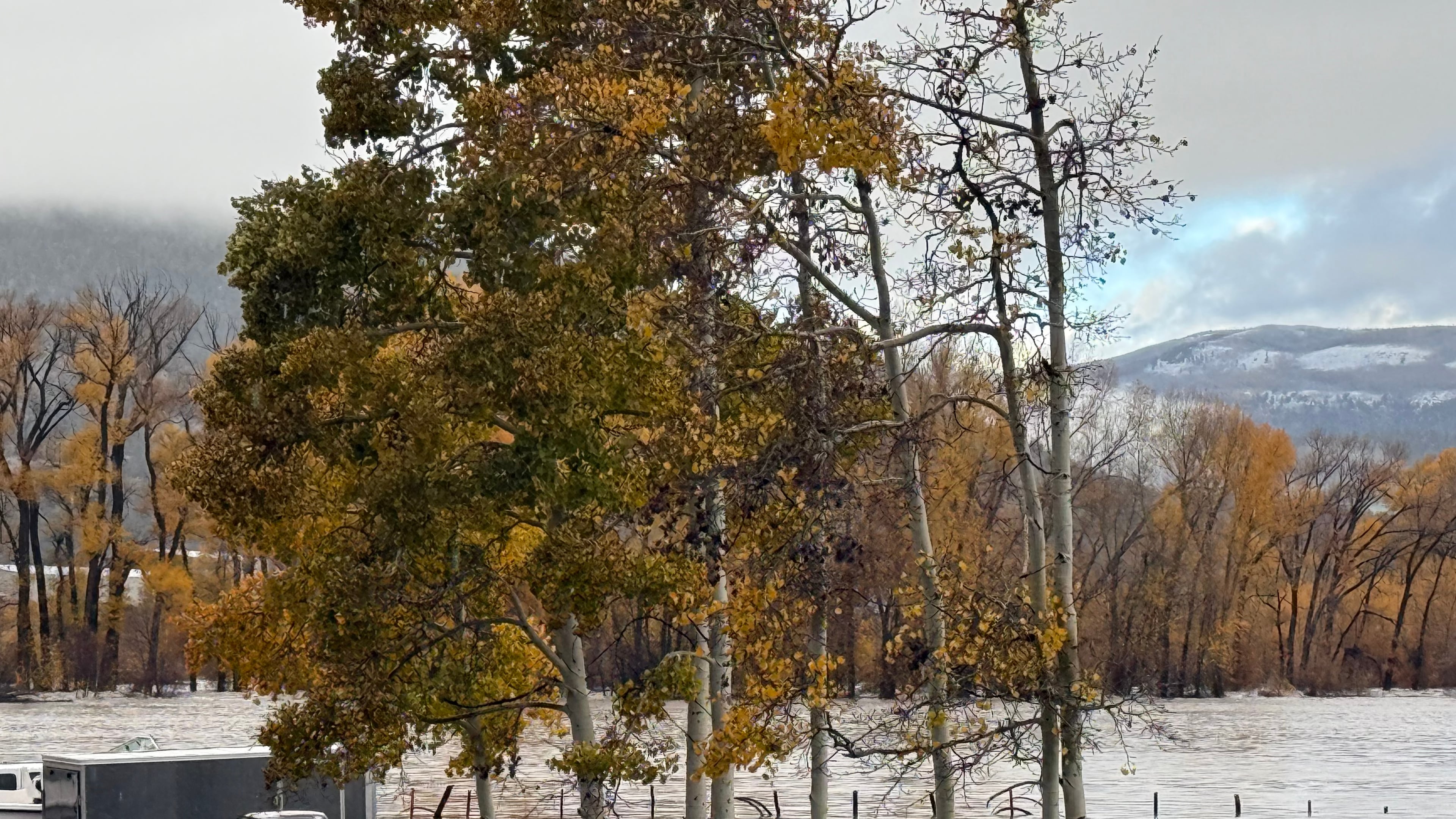 Pickup trucks are submerged along Highway 160 in South Fork, Colo., on Friday, Oct. 23, 2026. (South Fork Fire Rescue via AP)