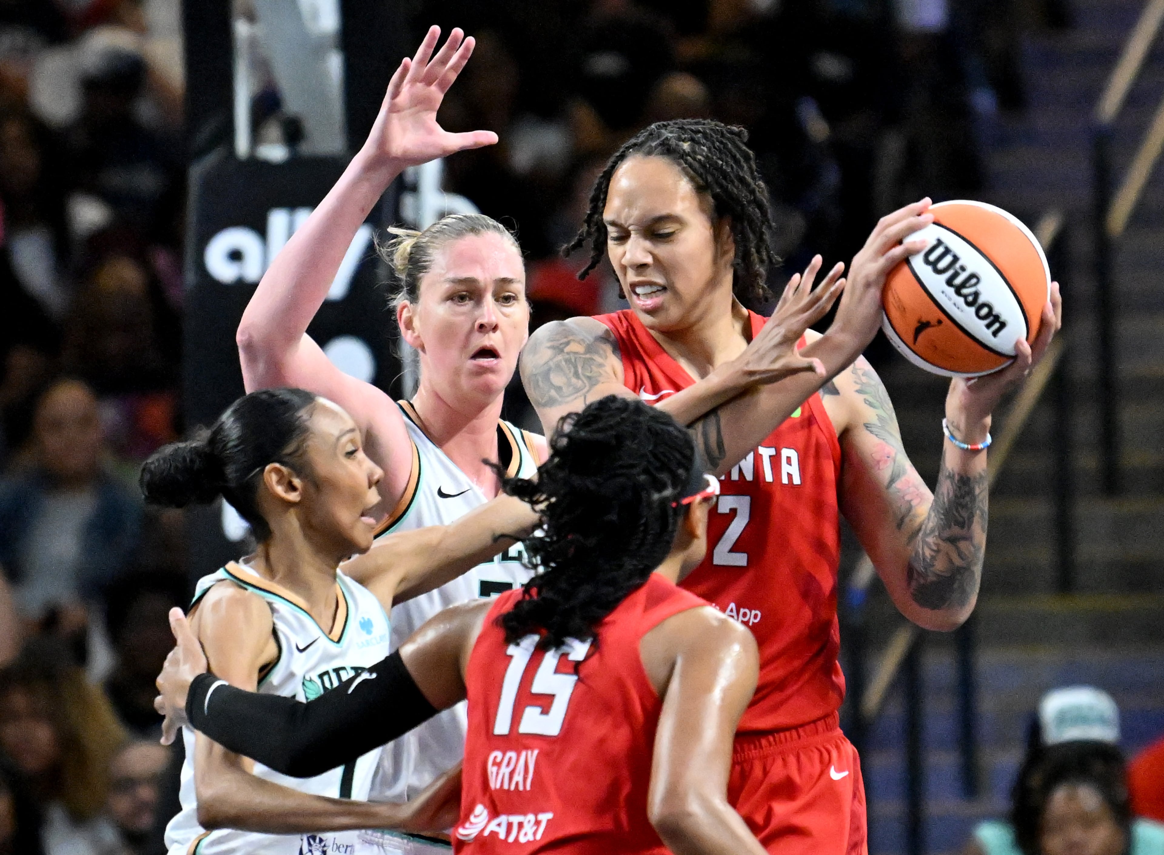 Brittney Griner (right), shown here playing for the Atlanta Dream as they battled the New York Liberty, has faced public attacks questioning her femininity and womanhood, guest columnist Tymia Ballard writes. (Hyosub Shin/AJC 2025)