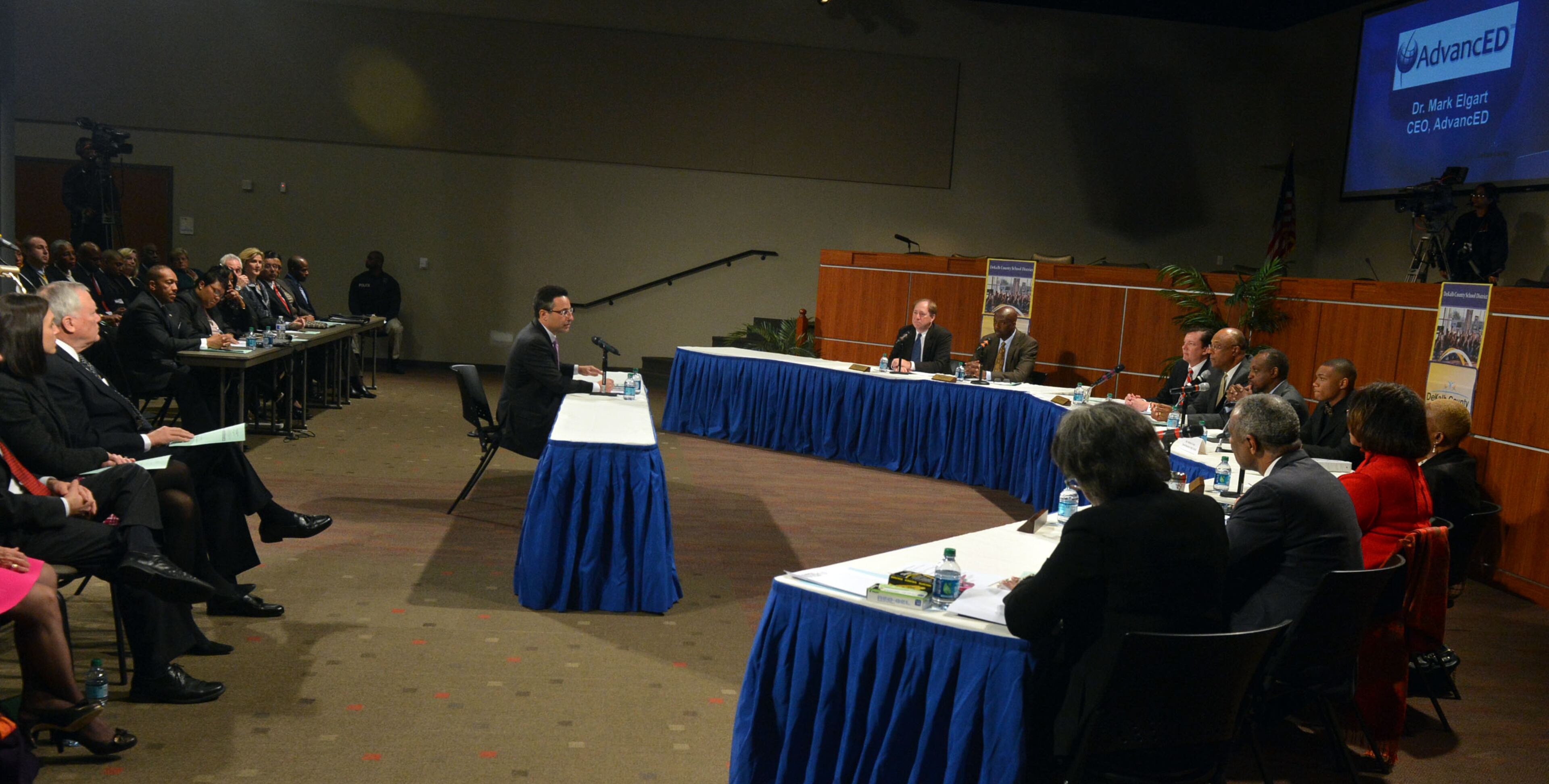 Gov. Nathan Deal (left) listens as Dr Mark Elgart, CEO of AdvancED makes a presentation before the DeKalb County School Board and a standing room only crowd Tuesday, January 21, 2014. The Southern Association of Colleges and Schools has cleared the DeKalb school district from its probationary status saying the threat to its accreditation is no longer eminent. However, Elgart, the SACS chief, says the district is still under watch and they are now under something called accreditation warning. Gov. Nathan Deal was also there to applaud the school district on its progress. Deal removed six board members last year after the district was placed on probation for mismanagement. KENT D. JOHNSON/KDJOHNSON@AJC.COM
