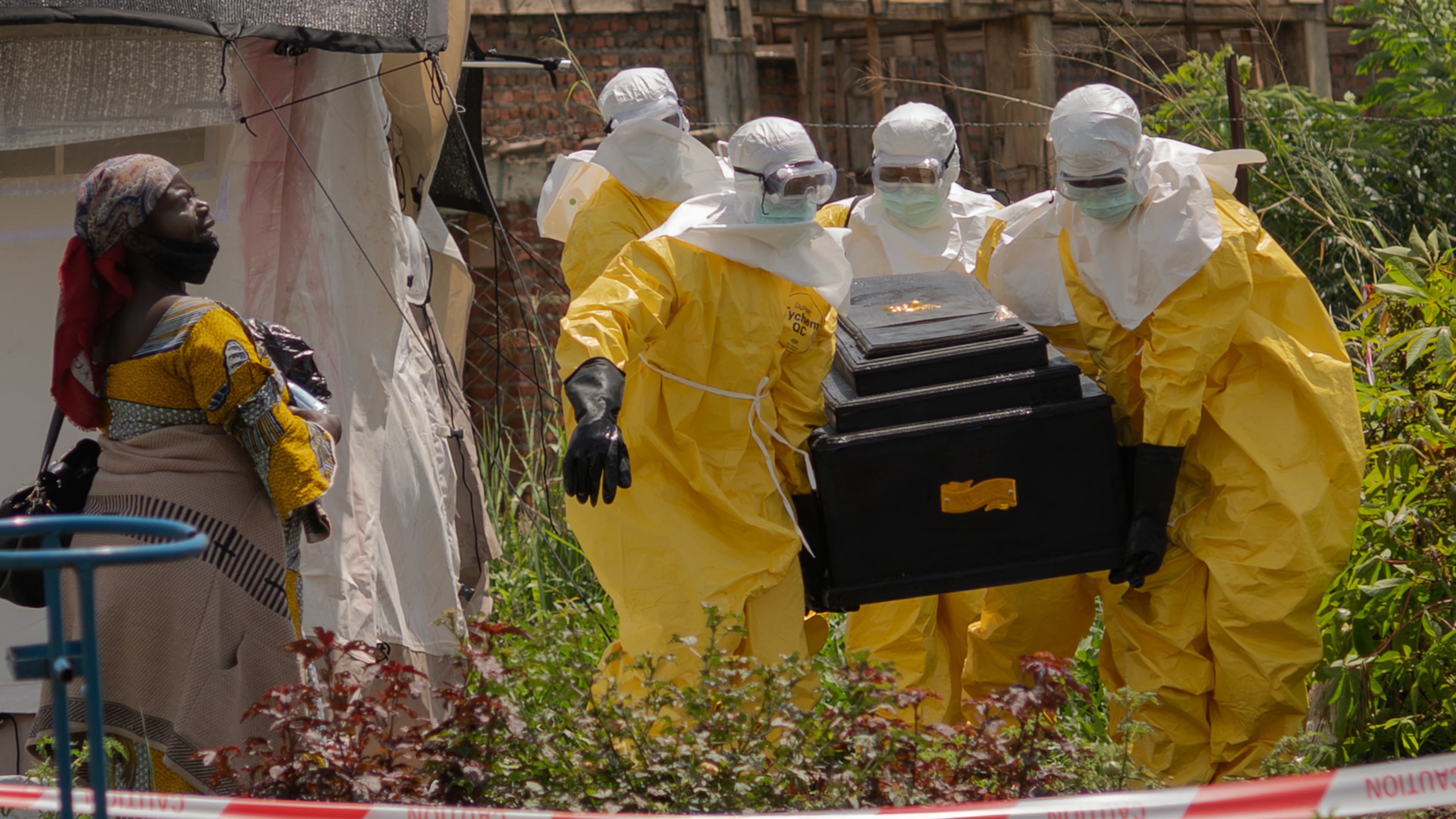 A woman cries as Red Cross workers carry the coffin of a person who died of Ebola from a health center in Rwampara, Congo, Wednesday, May 20, 2026. (AP Photo/Moses Sawasawa)