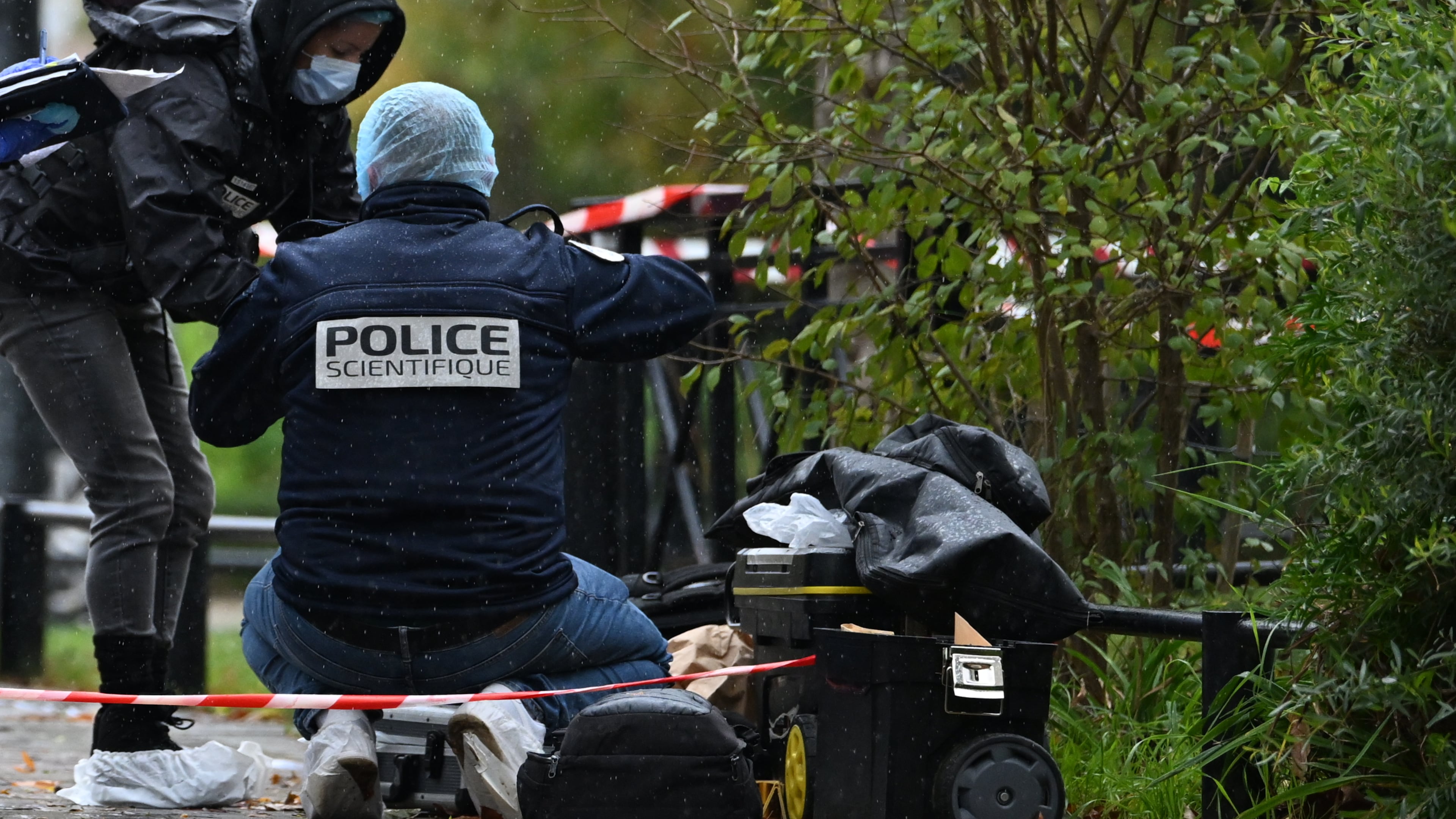 Forensic investigators search for evidence after a shooting in Trappes, outside Paris, Friday, Oct. 23, 2026. (AP Photo/Emma Da Silva)