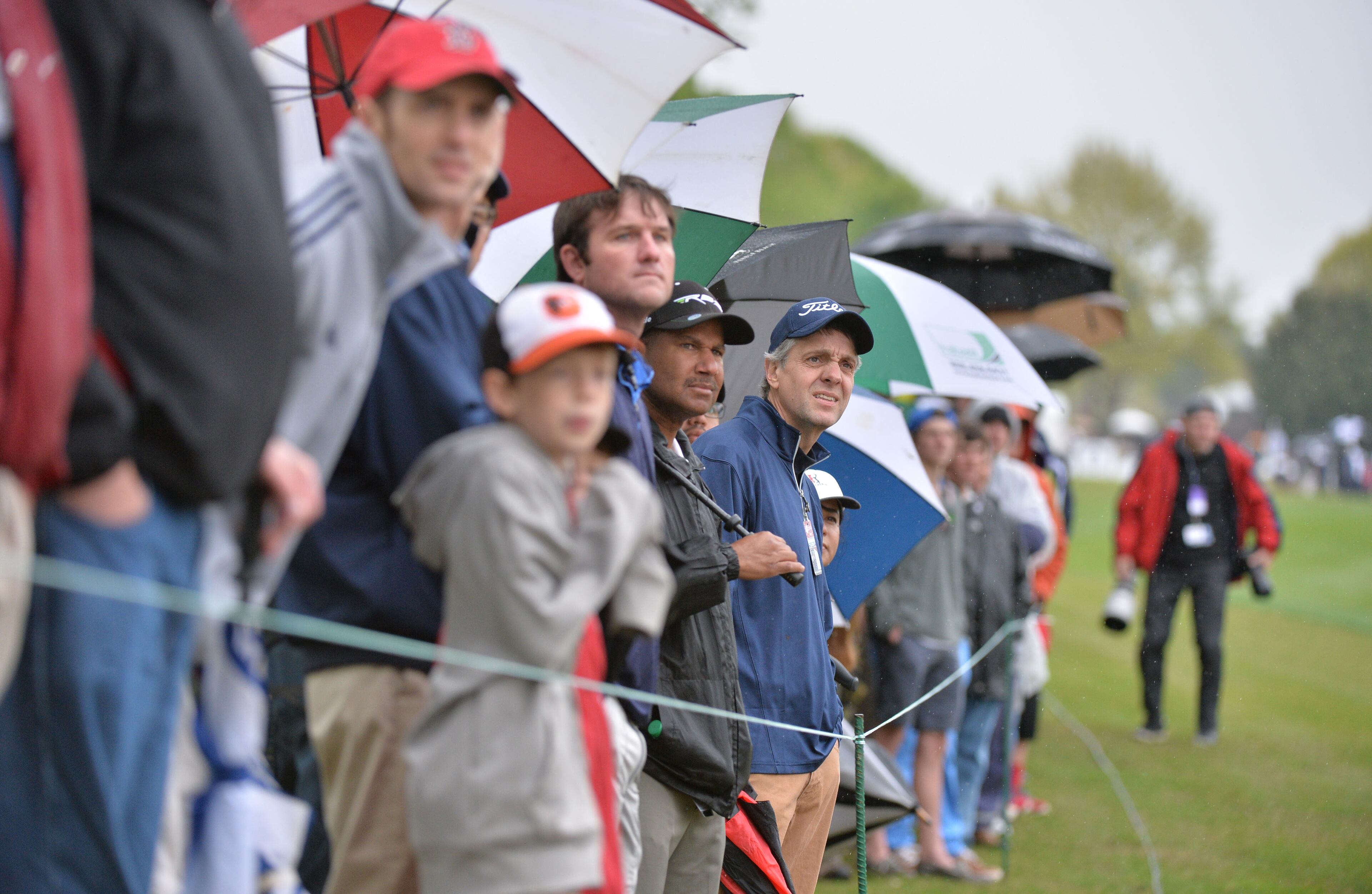 Spectators watch as Fred Couples hits his second shot on the No. 10 green during the round one of the 2014 Greater Gwinnett Championship at TPC Sugarloaf in Duluth on Friday, April 18, 2014.