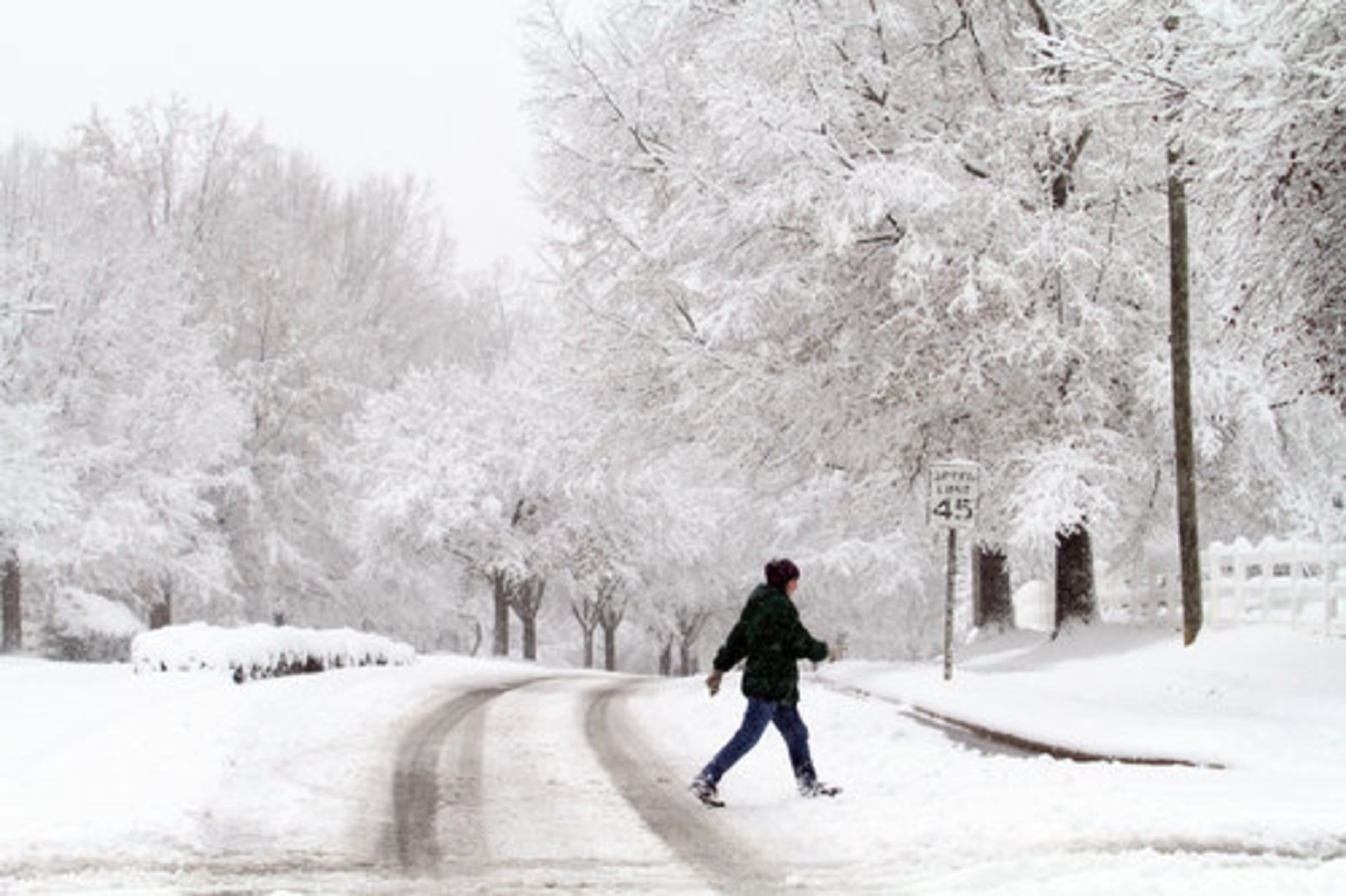 Margaret Ness takes a morning walk through snow in Raleigh, N.C., Sunday, Dec. 26, 2010.