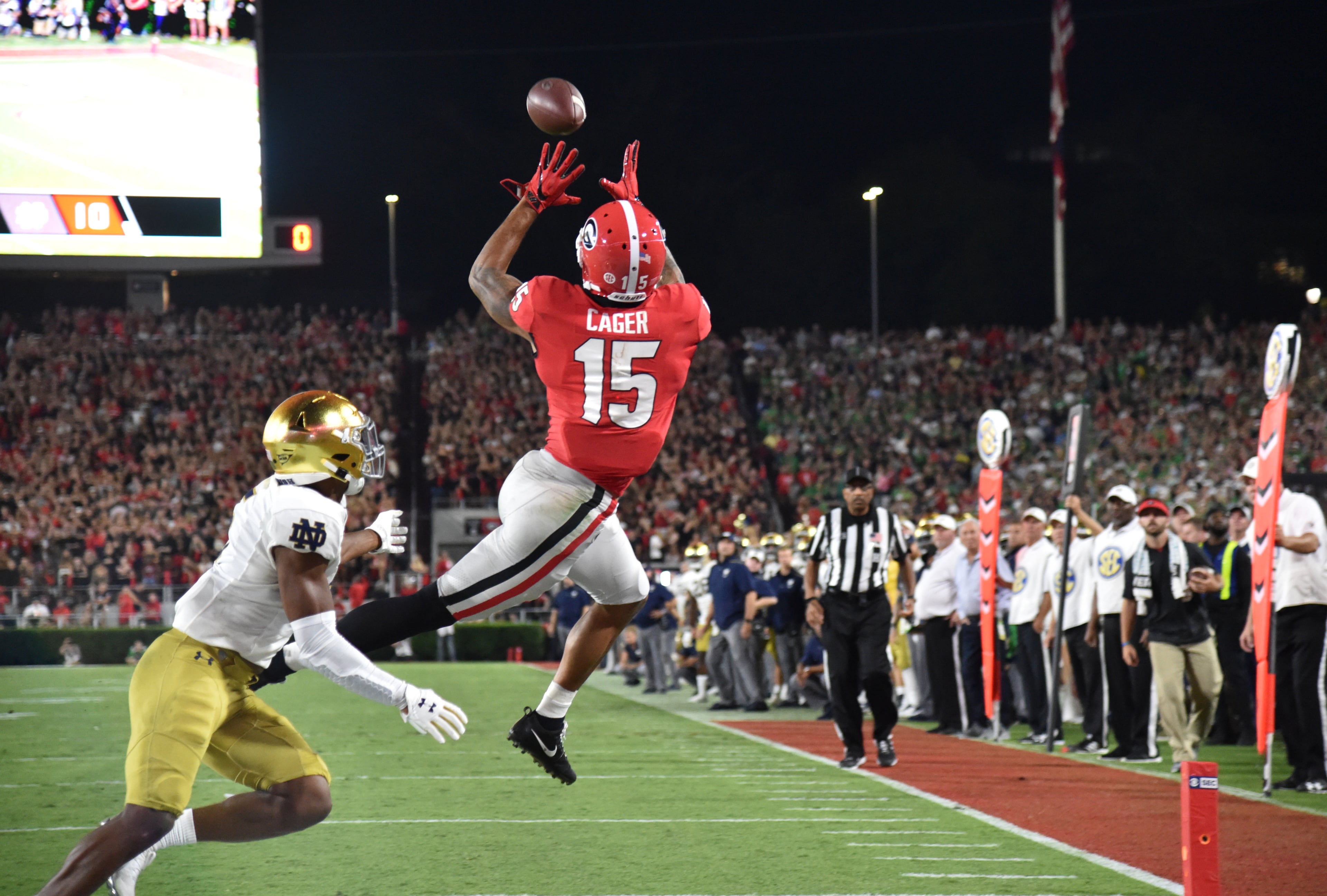 Georgia wide receiver Lawrence Cager (15) makes a touchdown catch over Notre Dame cornerback Troy Pride Jr. (5) in the second half in a NCAA college football at Sanford Stadium in Athens on Saturday, September 21, 2019. Georgia defeated Notre Dame 23-17. (Hyosub Shin / Hyosub.Shin@ajc.com)