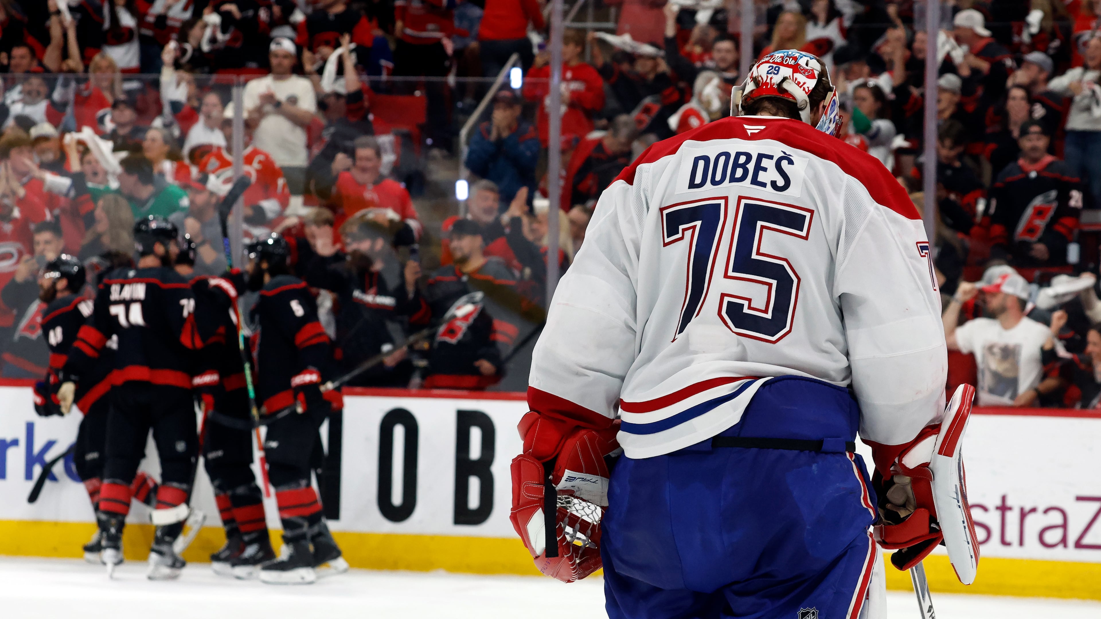 Carolina Hurricanes players celebrate after a goal by Nikolaj Ehlers as Montreal Canadiens goaltender Jakub Dobes (75) returns to the net during the second period in Game 2 of the Eastern Conference final NHL hockey Stanley Cup playoff series in Raleigh, N.C., Saturday, May 23, 2026. (AP Photo/Karl DeBlaker)