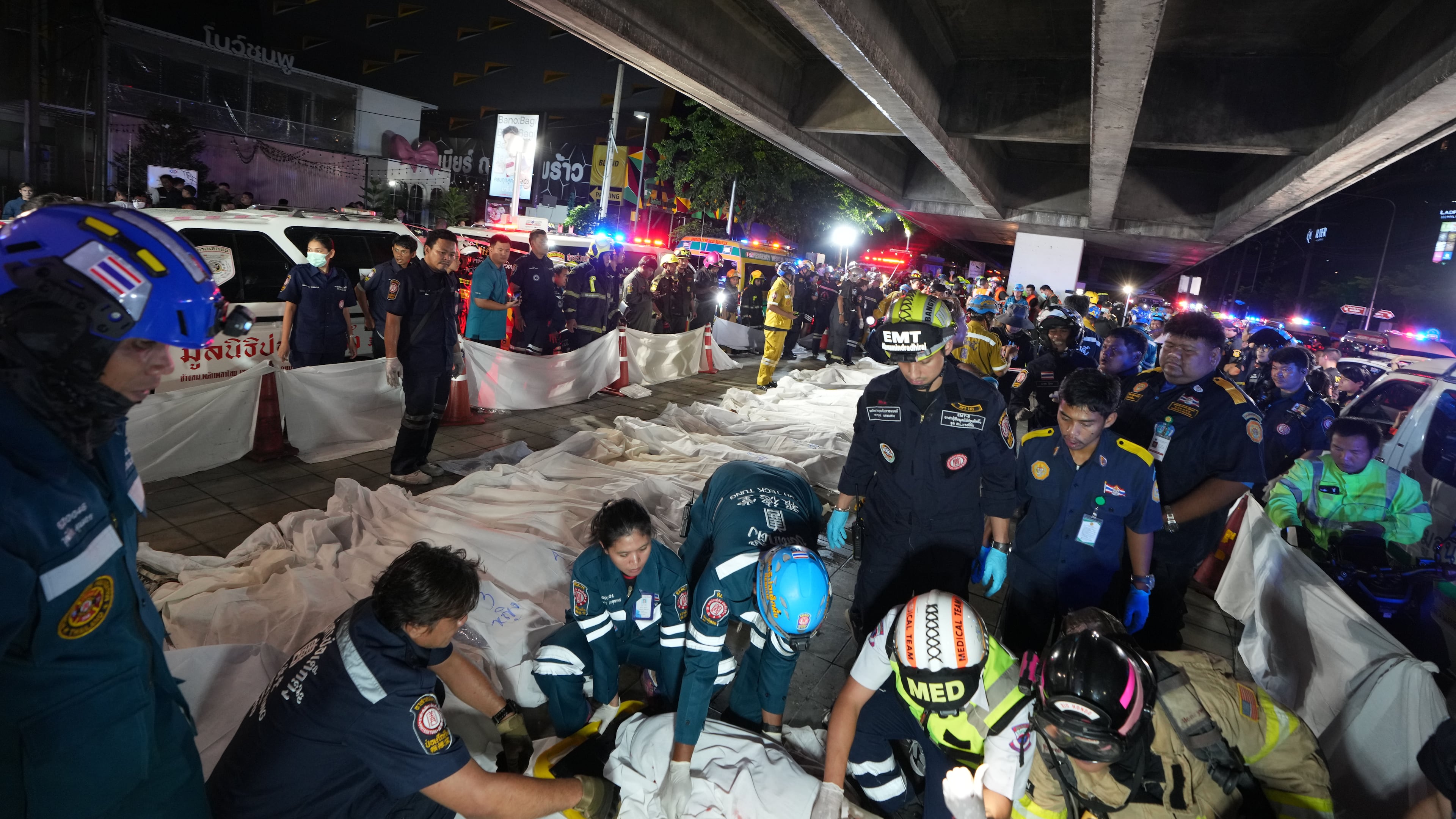 Bodies of victims of a fire are seen laid in a row in Bangkok, Thailand, Monday, July 13, 2026. (AP Photo/Sakchai Lalit)