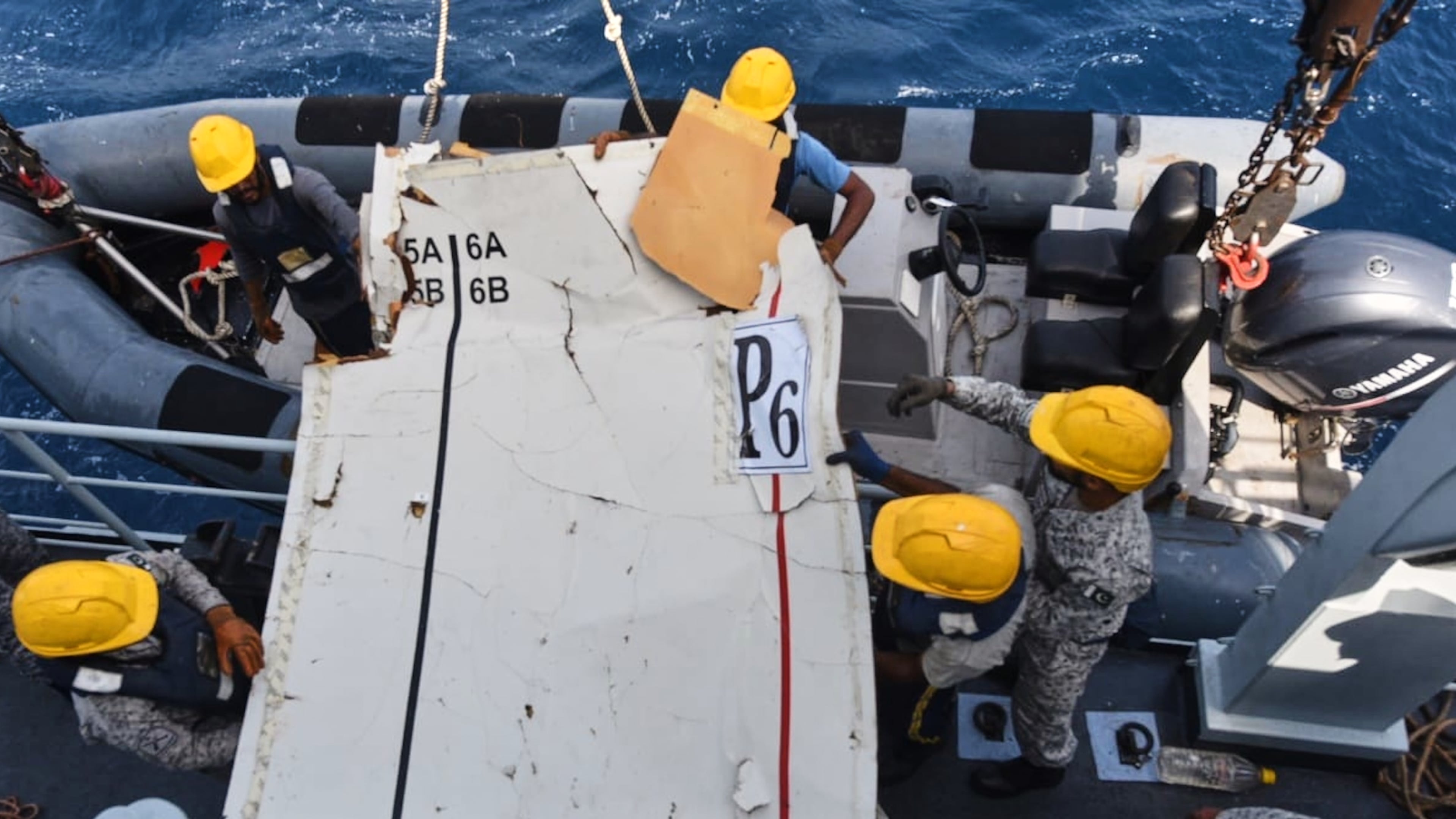 In this photo released by Pakistan Navy, Pakistan Navy personnel shift the wreckage of a cargo plane of the private carrier K2 Airways into a naval ship after recovering them from deep sea near Omara, a town some 360 kms. (220 miles) west of Karachi, Pakistan, Wednesday, July 8, 2026. (Pakistan Navy via AP)