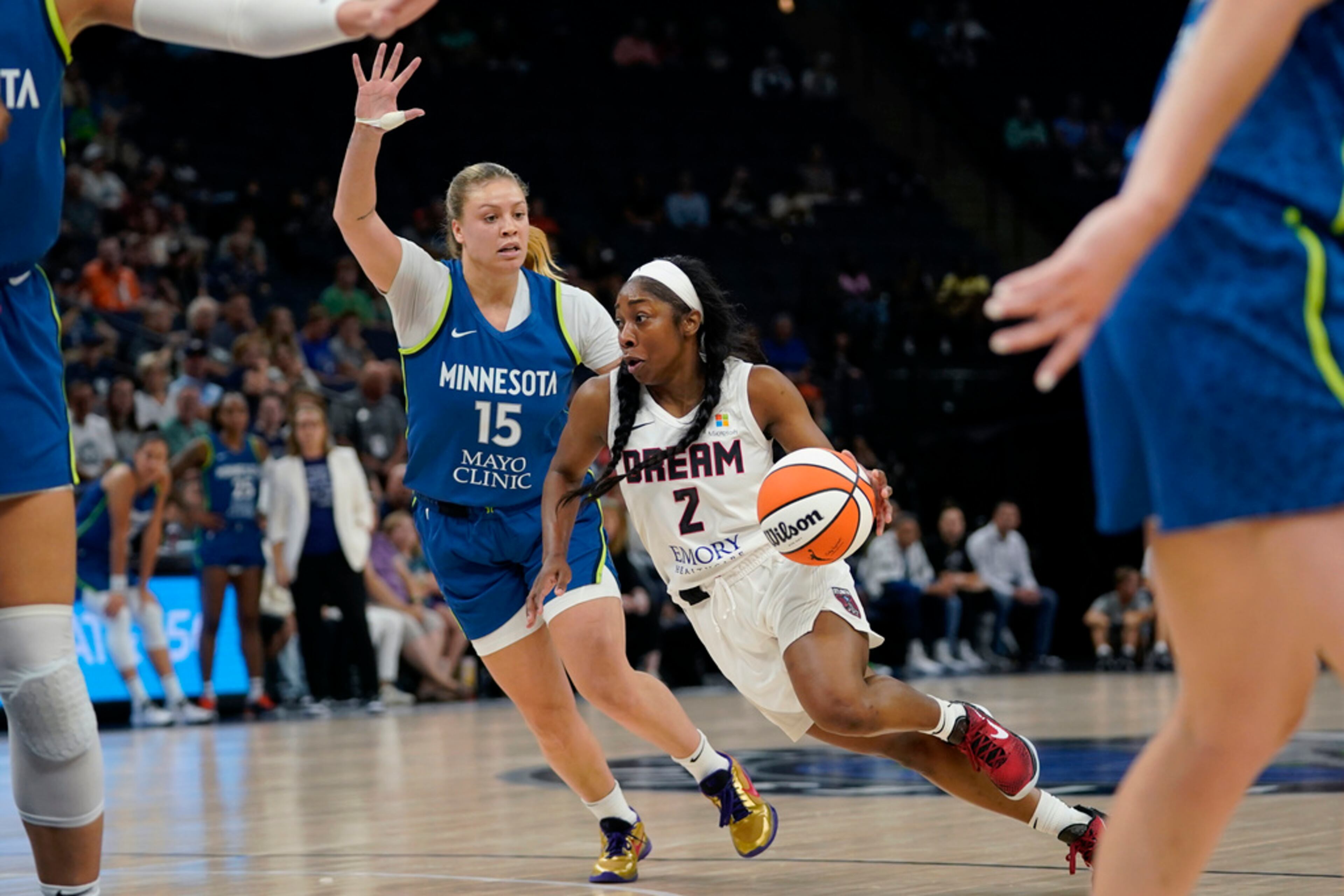 Atlanta Dream guard Aari McDonald (2) works toward the basket while defended by Minnesota Lynx guard Rachel Banham (15) during the first half of a WNBA basketball game Friday, Sept. 1, 2023, in Minneapolis. (AP Photo/Abbie Parr)