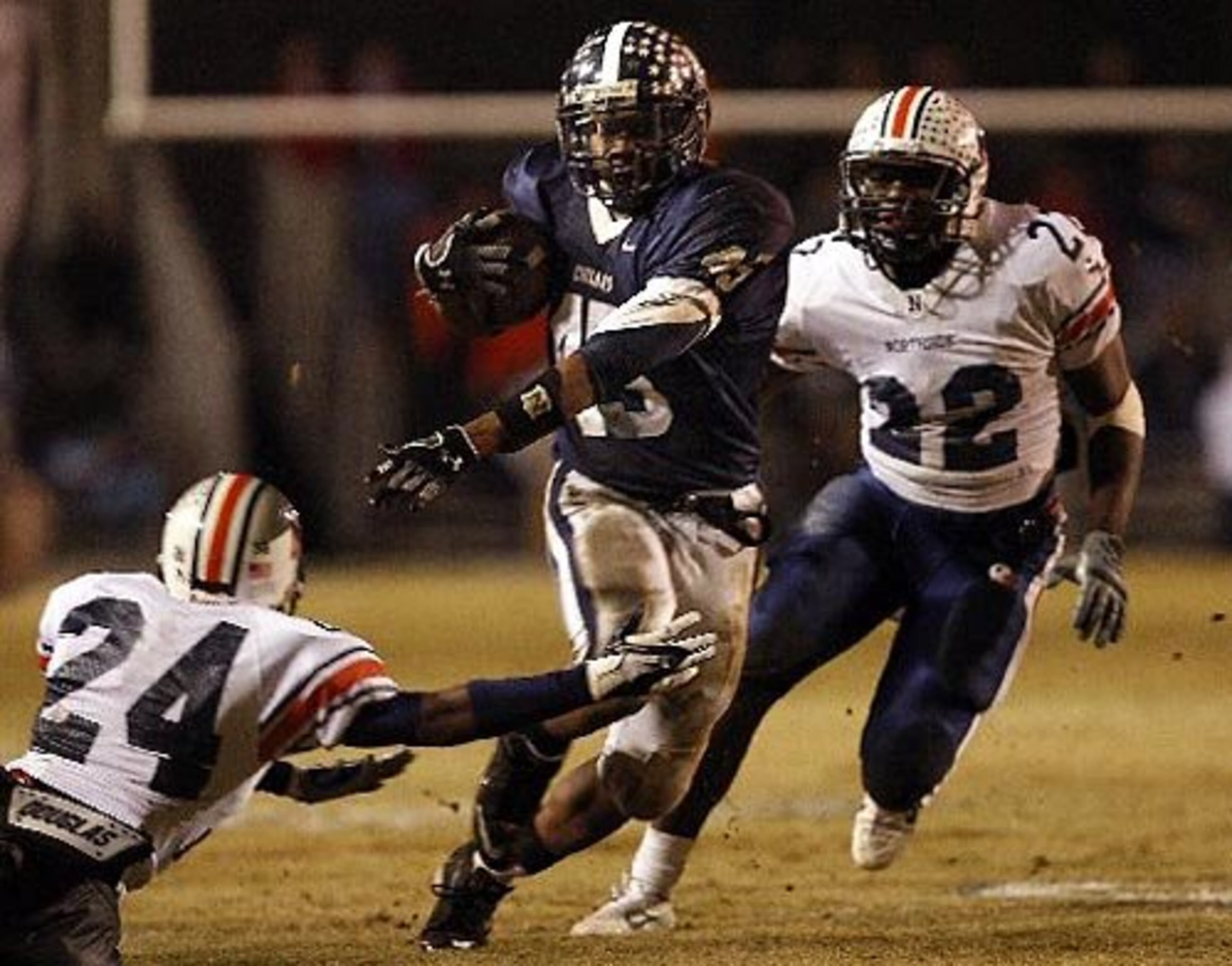 Newnan running back Christopher Robinson (45) makes a move on Northside-Warner Robins defender Joe Sturn (24) as teammate Deilouse Jackson (22, right) pursues during the first half.