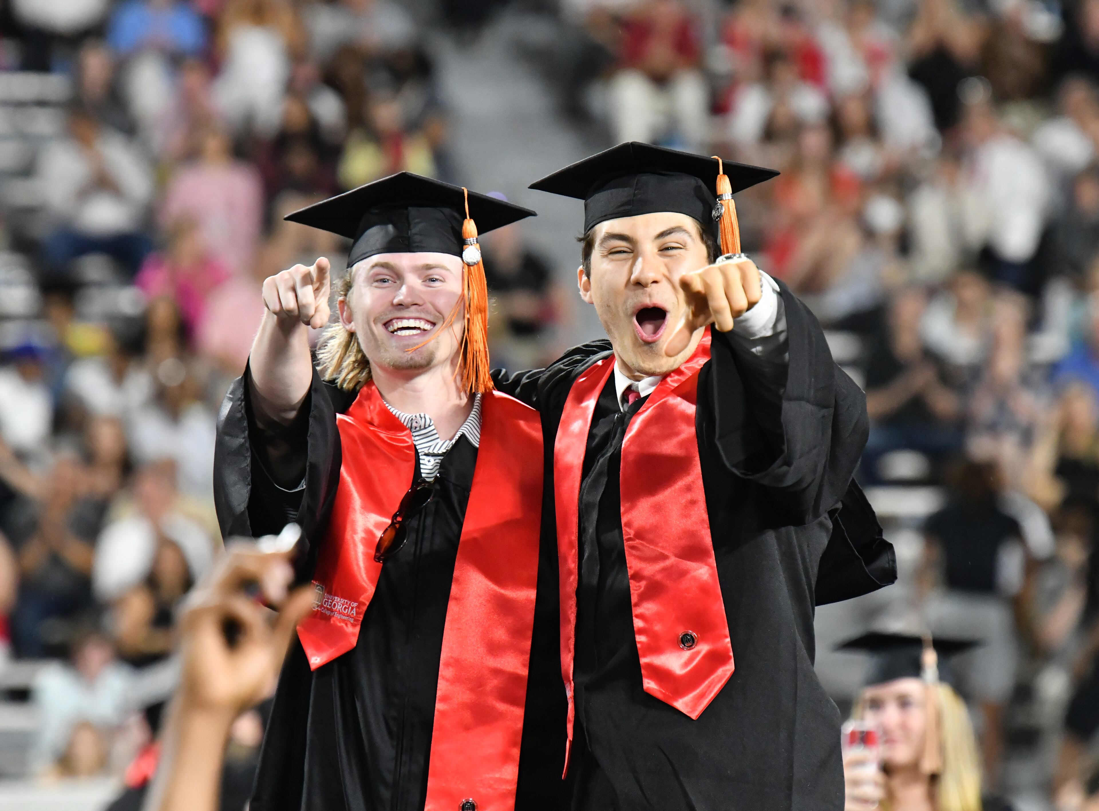 UGA graduates react after moving their tassels during the 2022 Spring Undergraduate Commencement at Sanford Stadium in Athens on on Friday, May 13, 2022. (Hyosub Shin / Hyosub.Shin@ajc.com)