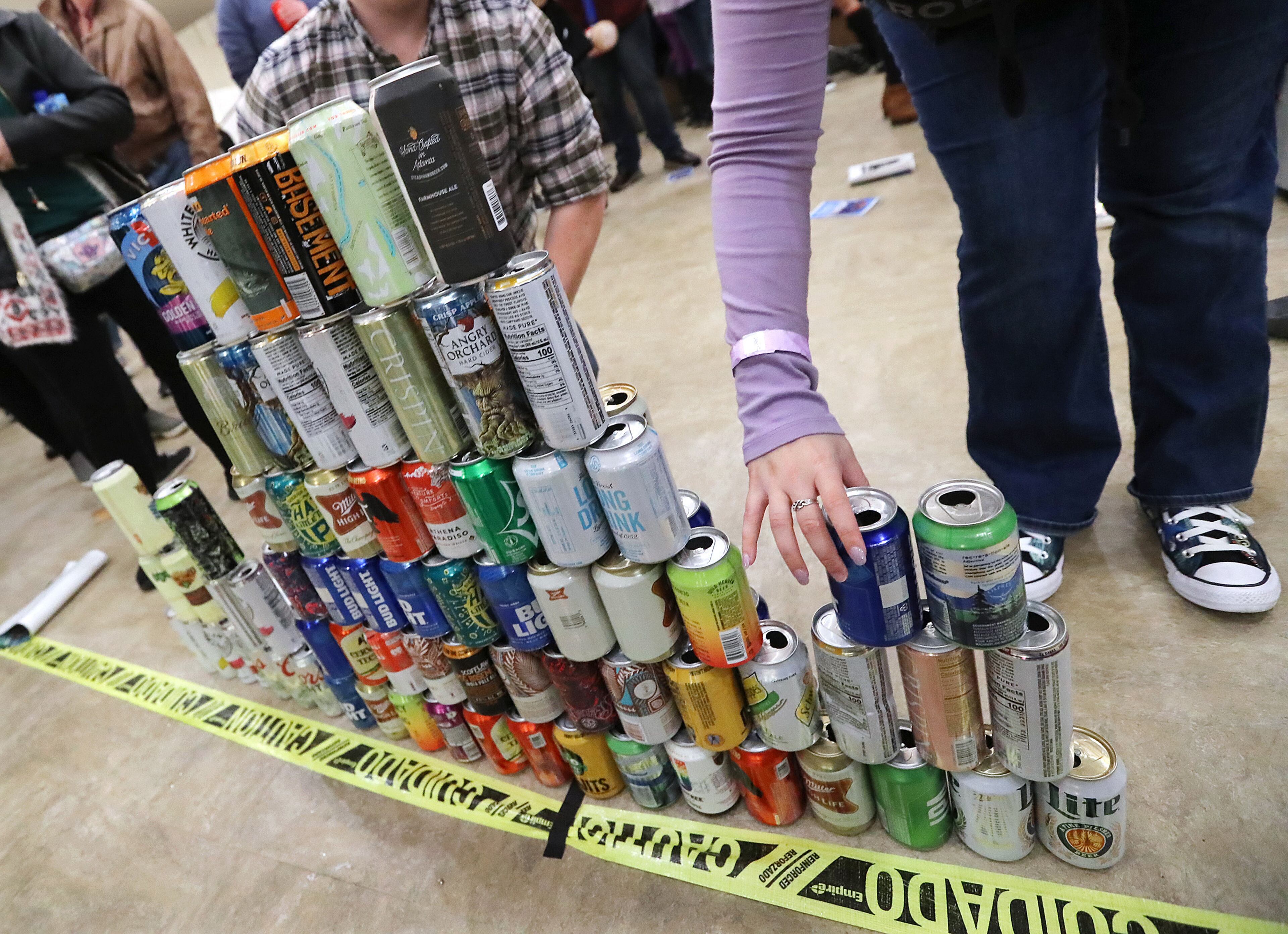 January 25, 2020 Atlanta: Atlanta Roller Derby fans stack up empty beer cans during a pre-pandemic game at the Yaarab Shrine Center on Saturday, January 25, 2020, in Atlanta. At the conclusion of games the player that wins the blocker MVP award slides throught the cans in a winners tradition. Curtis Compton ccompton@ajc.com