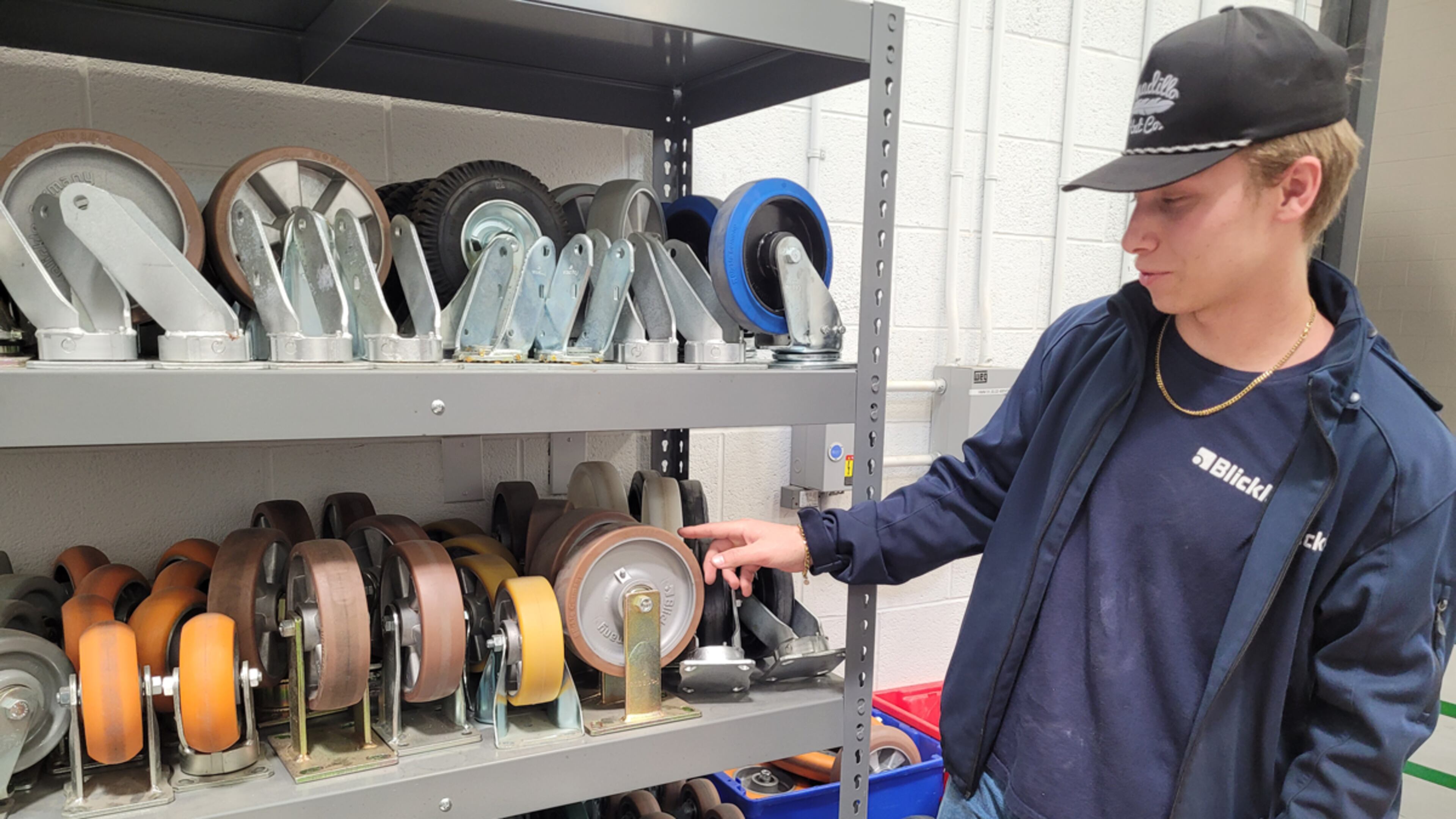Walker Reese, who started his apprenticeship at Blickle Wheels and Casters at 15 and is now a full-time employee, shows off some of the wheels the company makes. (Photo Courtesy of Patrick O’Donnell)