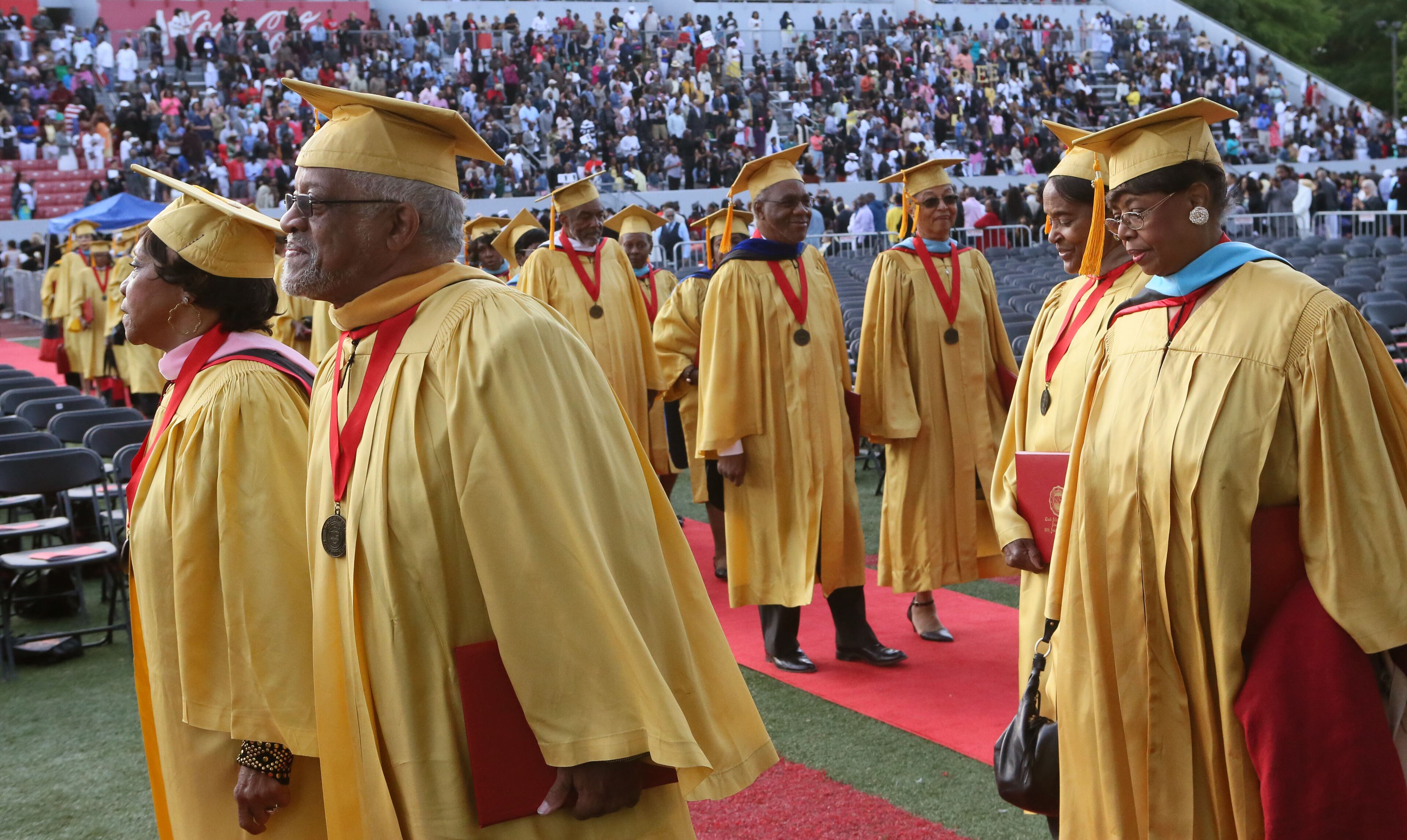 May 16, 2016 - Atlanta - Golden Sons and Daughters, members of the class of 1966, process in to the graduation. Clark Atlanta University class of 2016 filled Panther Stadium Monday morning for it's 27th annual Commencement Service. The keynote speaker was retired astronaut Mae Jemison, the first woman of color in Space. Honorary degrees were awarded to Hamilton Bohannon, a 1964 graduate of Clark College; Roland Carter; Congressman John Conyers, and Congressman Hank Johnson, a 1976 Clark College graduate. BOB ANDRES / BANDRES@AJC.COM