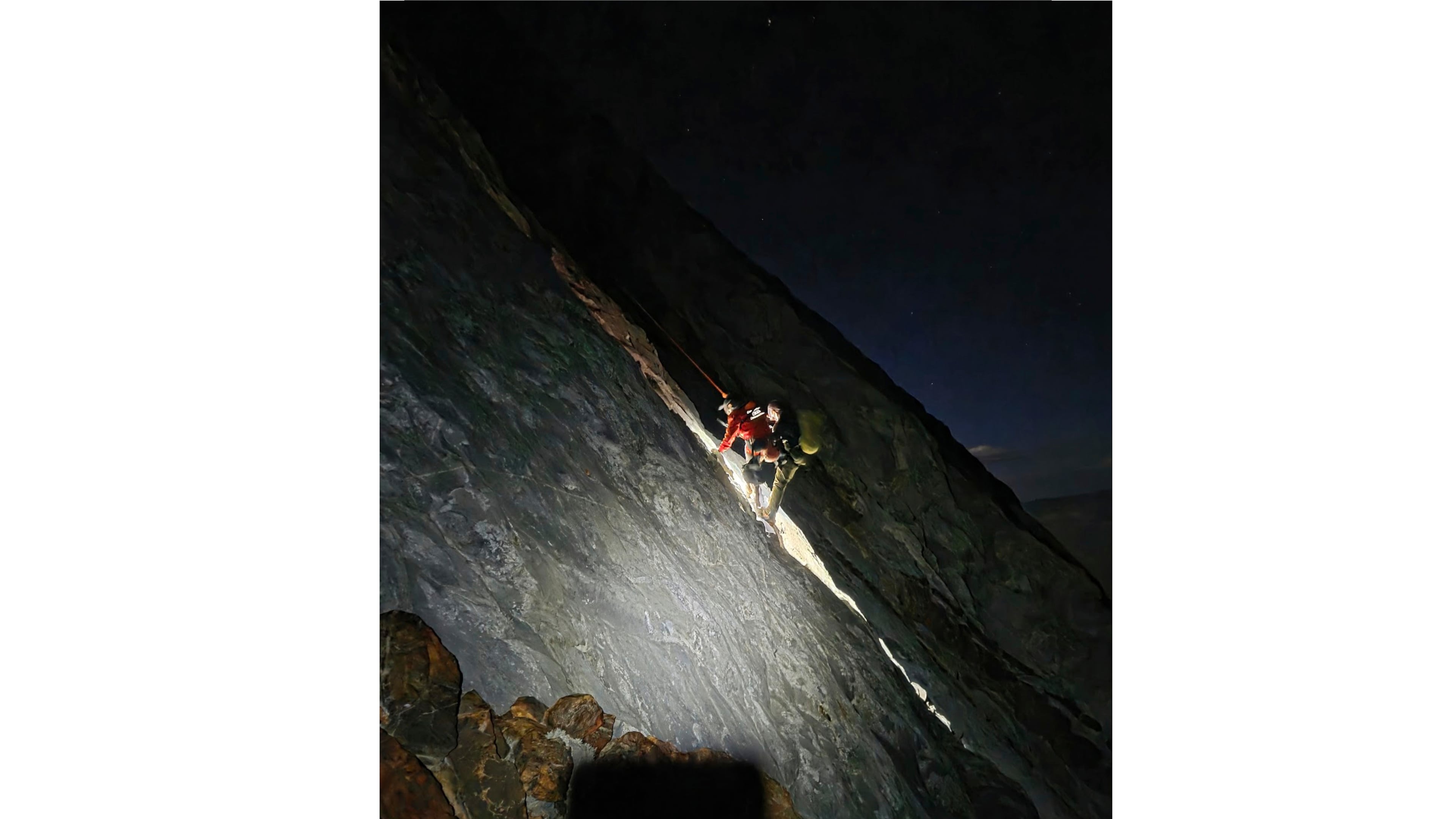 This photo released by Mono County Sheriff Search and Rescue, shows a rescuer with the man who was stranded, Rob Martin, right, after he was rescued on a ledge in the Sierra Nevada, Calif., on Aug. 22, 2026. (Mono County Sheriff Search and Rescue via AP)