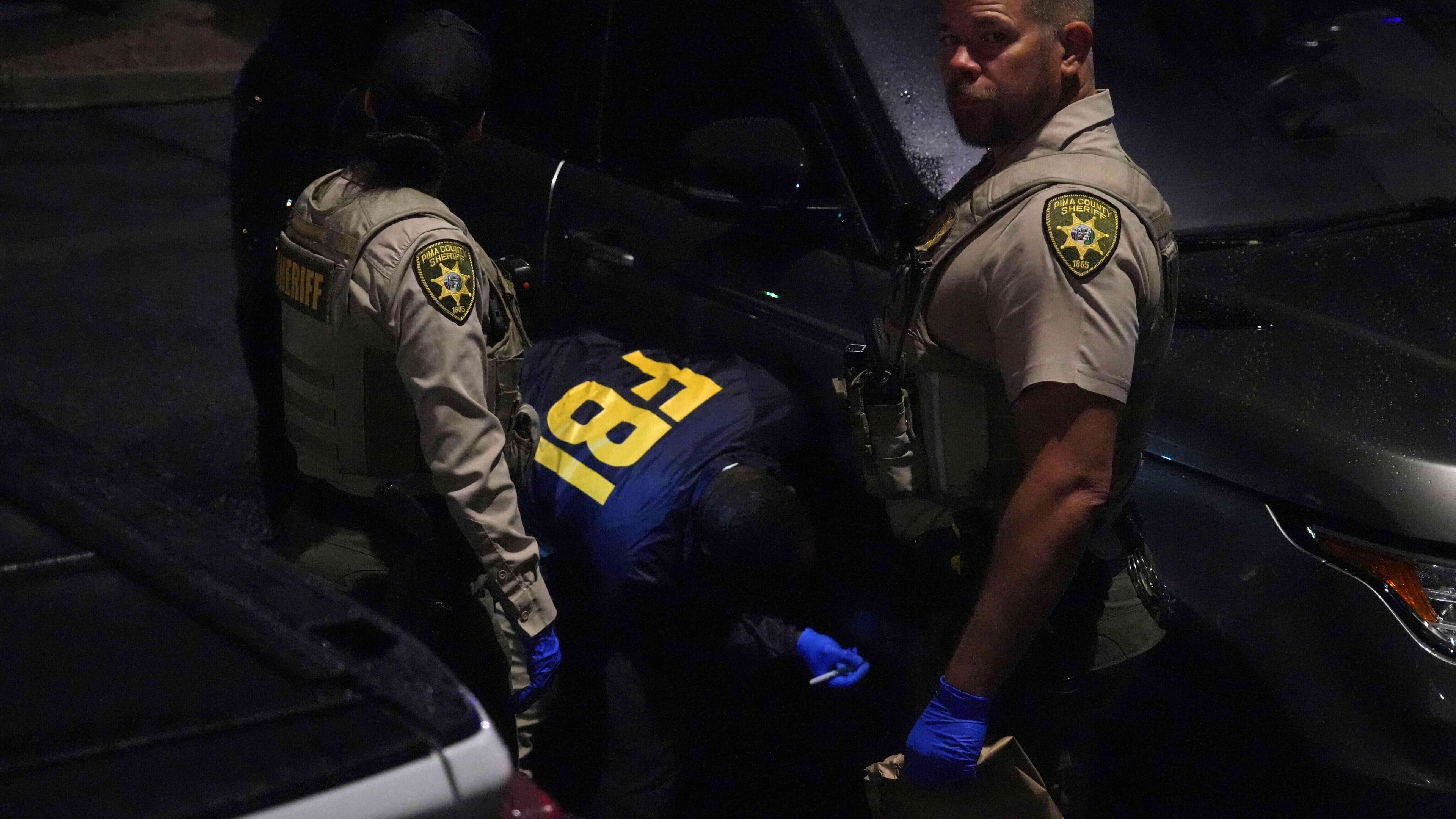 Pima County sheriff and FBI work on a Range Rover in a Culver’s parking lot in Tucson, Ariz. early Saturday, Feb. 14, 2026. (AP Photo/Ty ONeil)